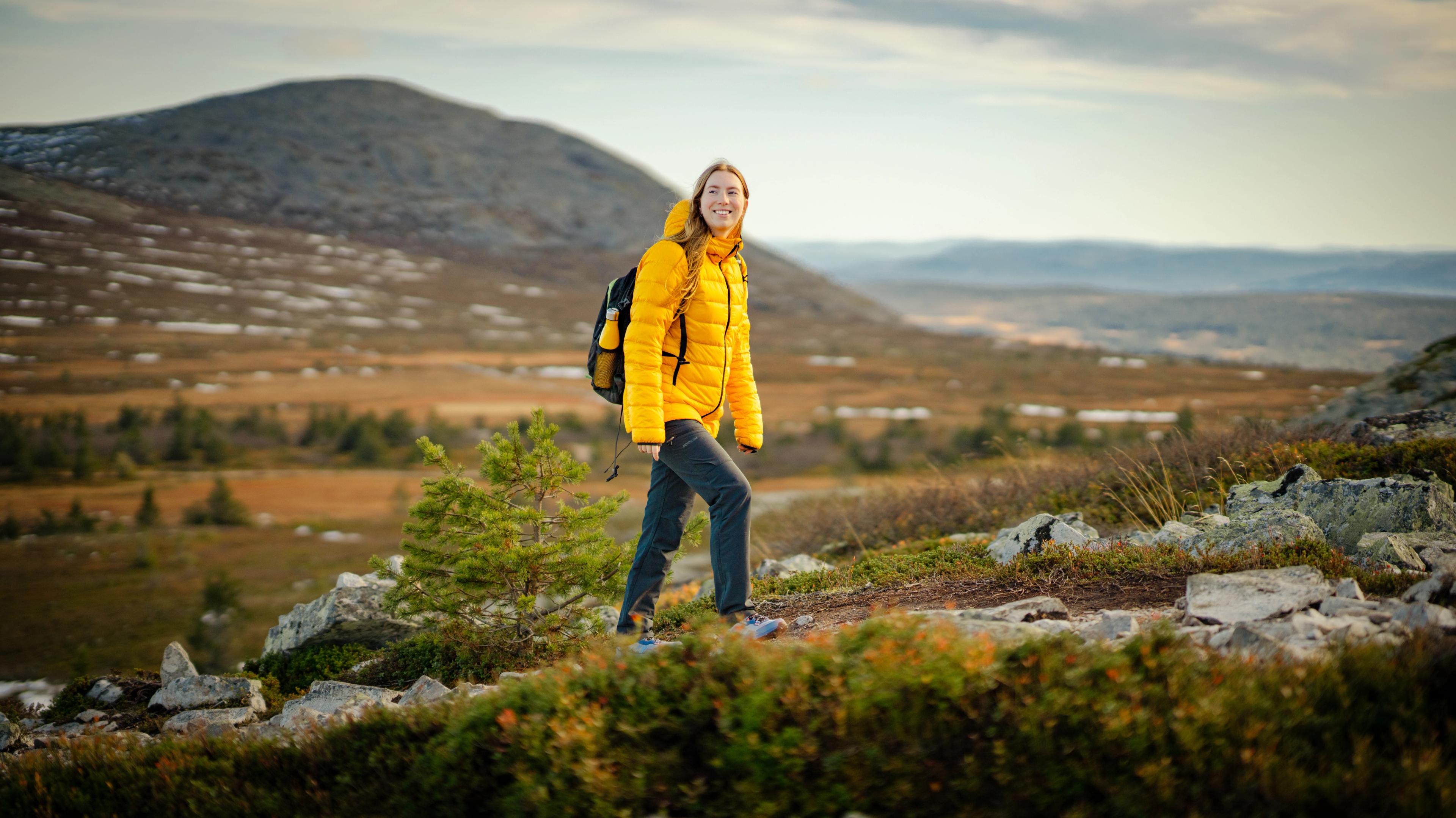 A woman hiking up a mountain in Trysil