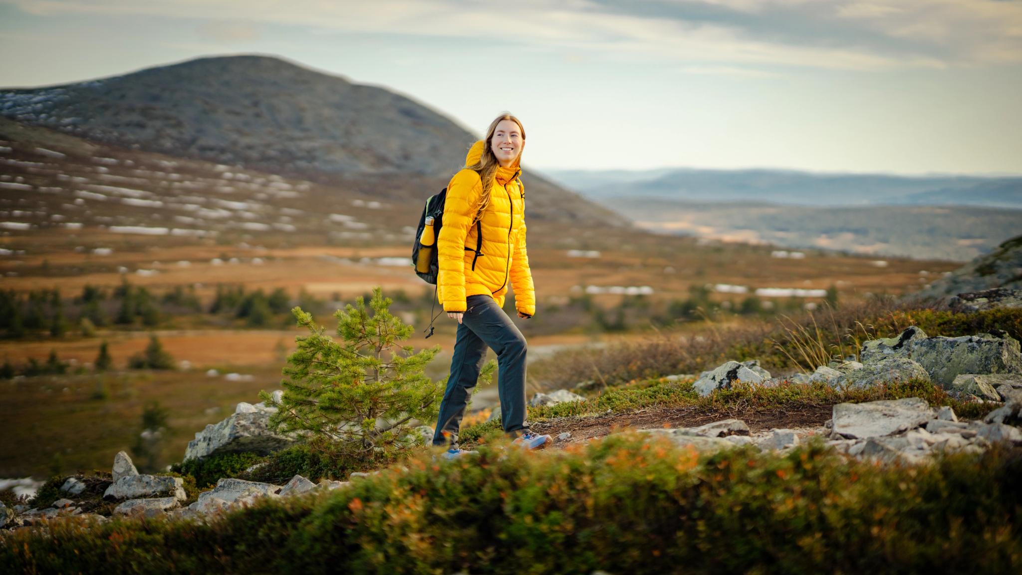 A woman hiking up a mountain in Trysil