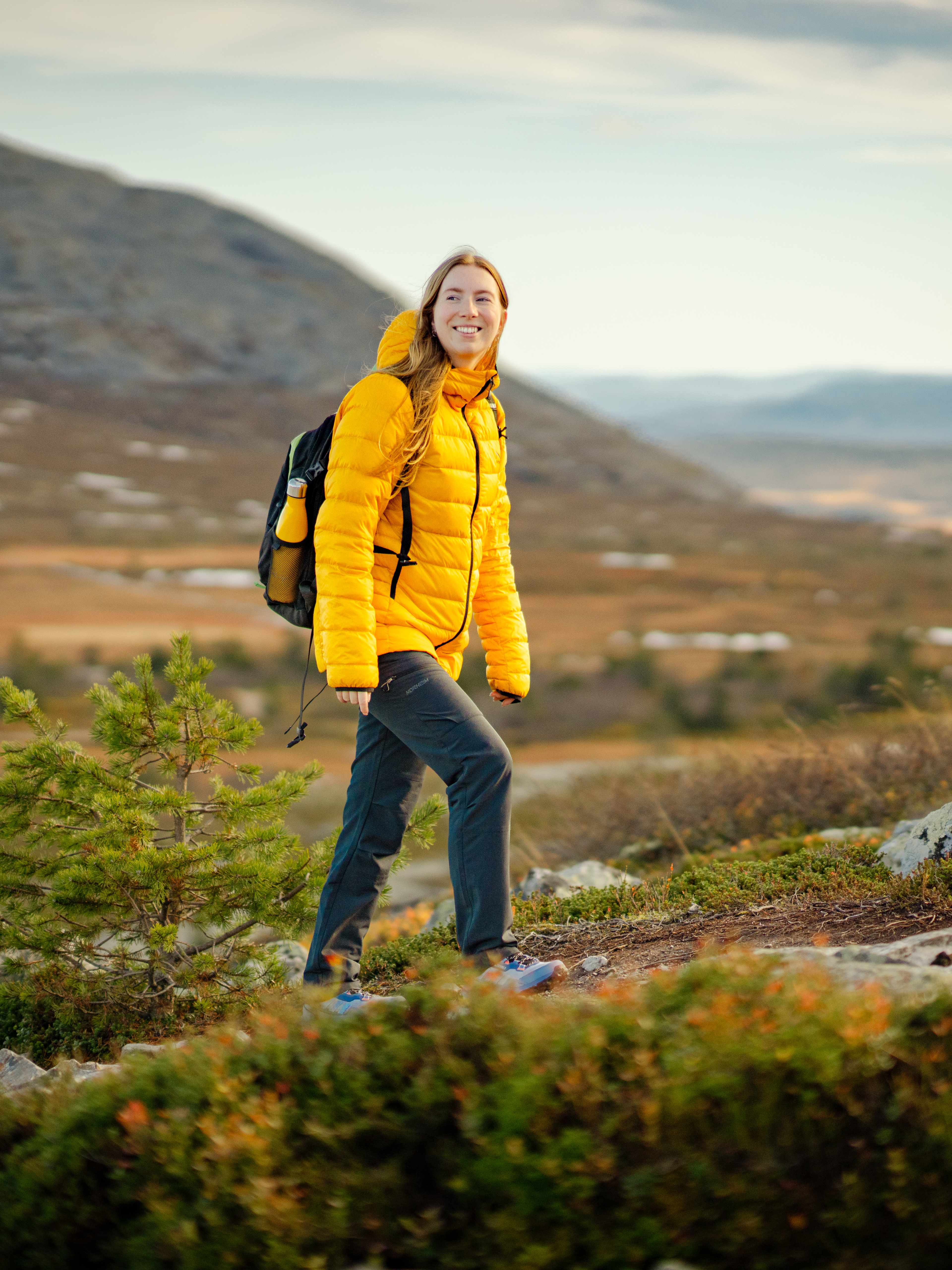 A woman hiking up a mountain in Trysil
