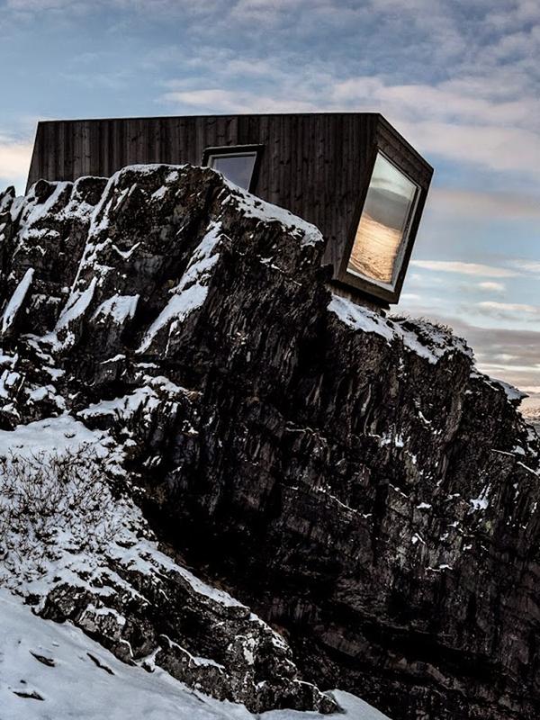 A birdwatching shelter in the snowy landscape of Kongsfjord, Northern Norway