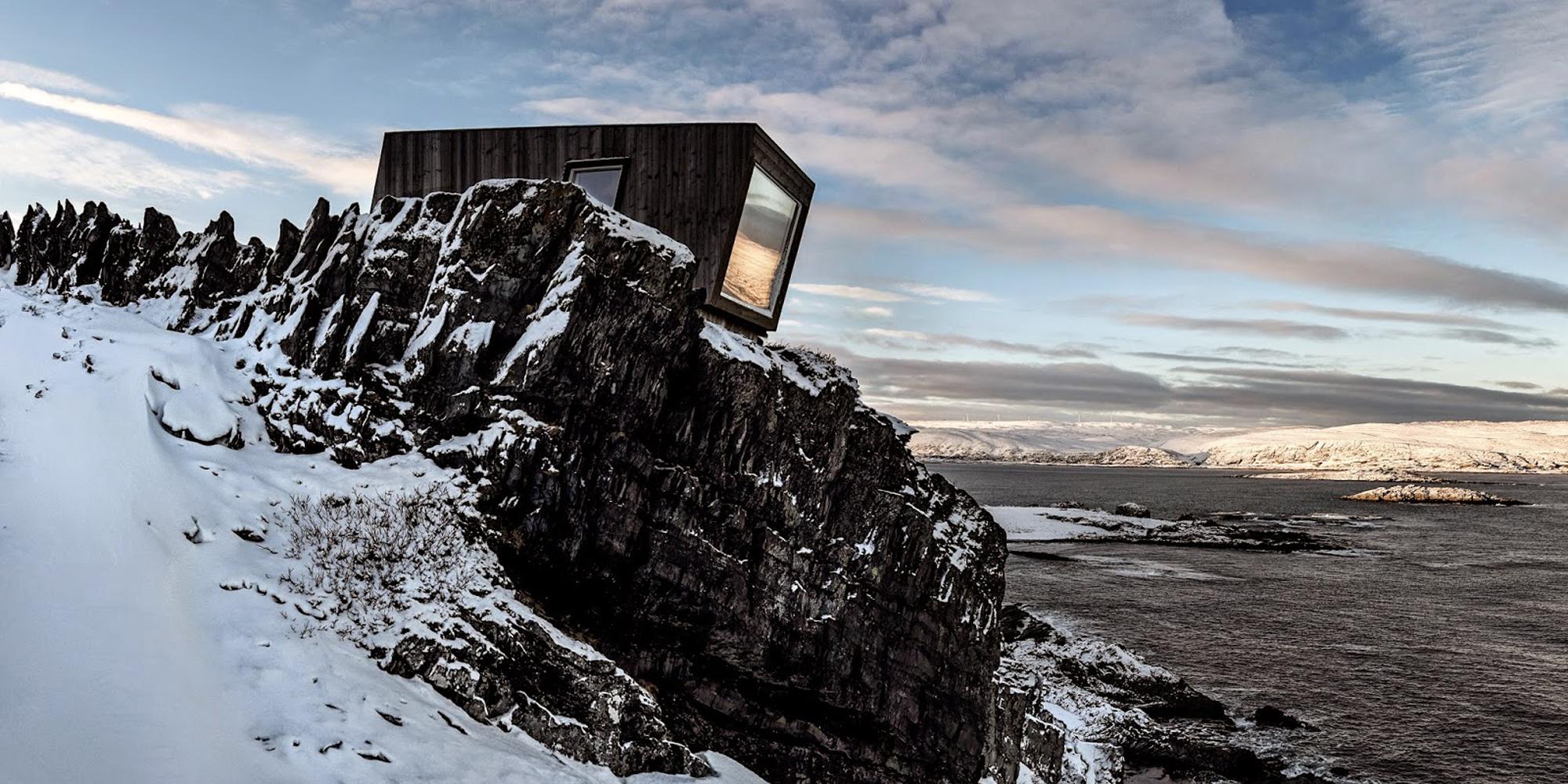 A birdwatching shelter in the snowy landscape of Kongsfjord, Northern Norway