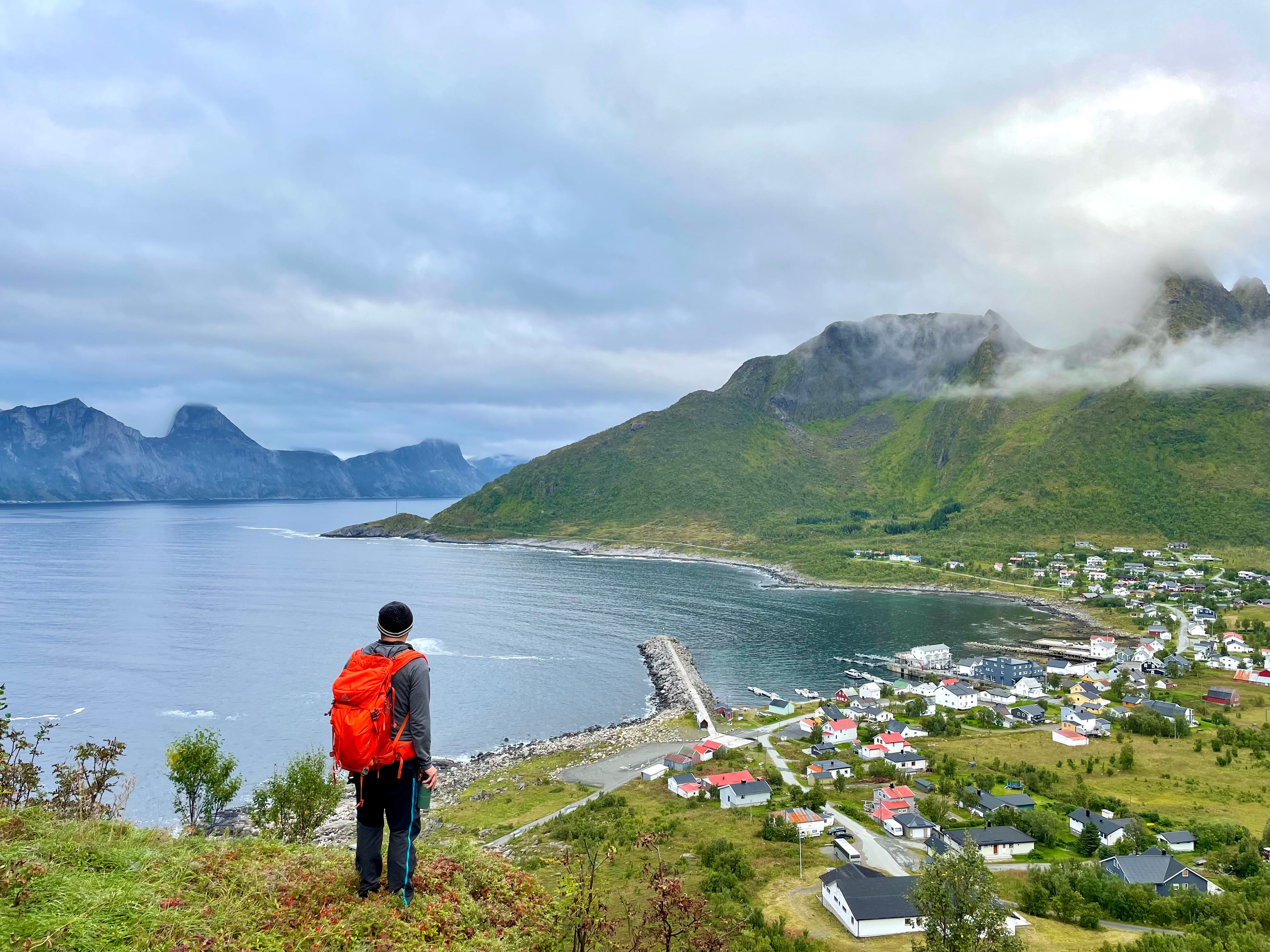 A man hiking over Medfjordvær in Senja
