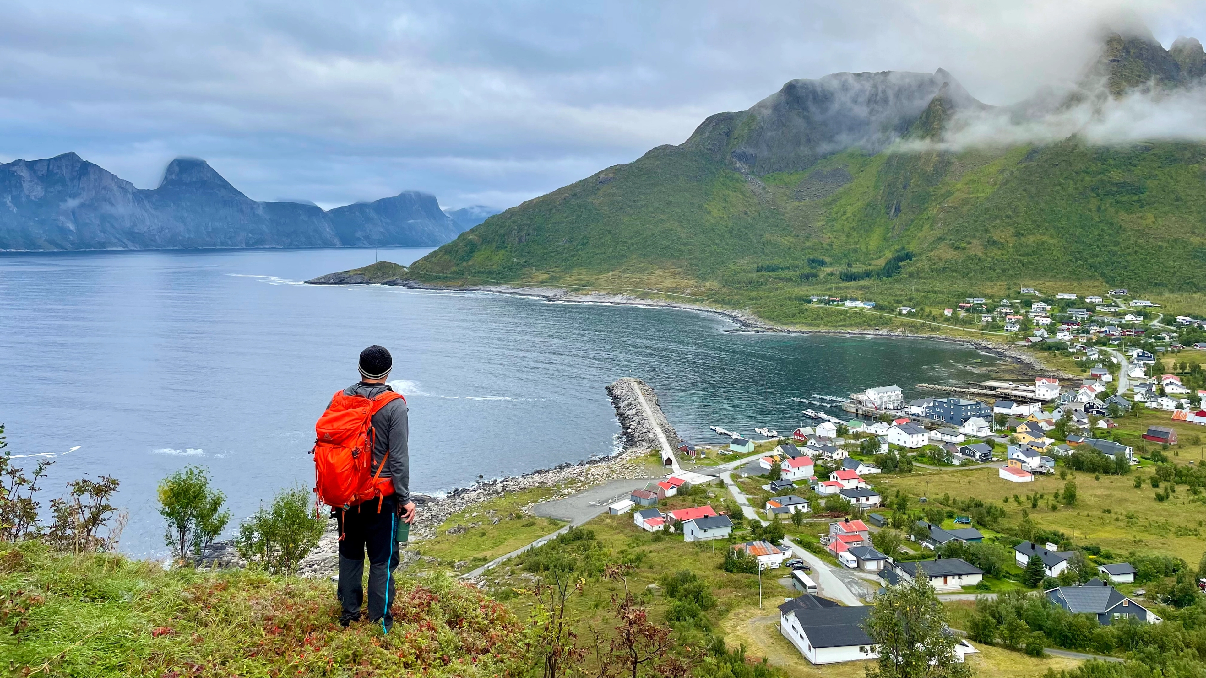 A man hiking over Medfjordvær in Senja