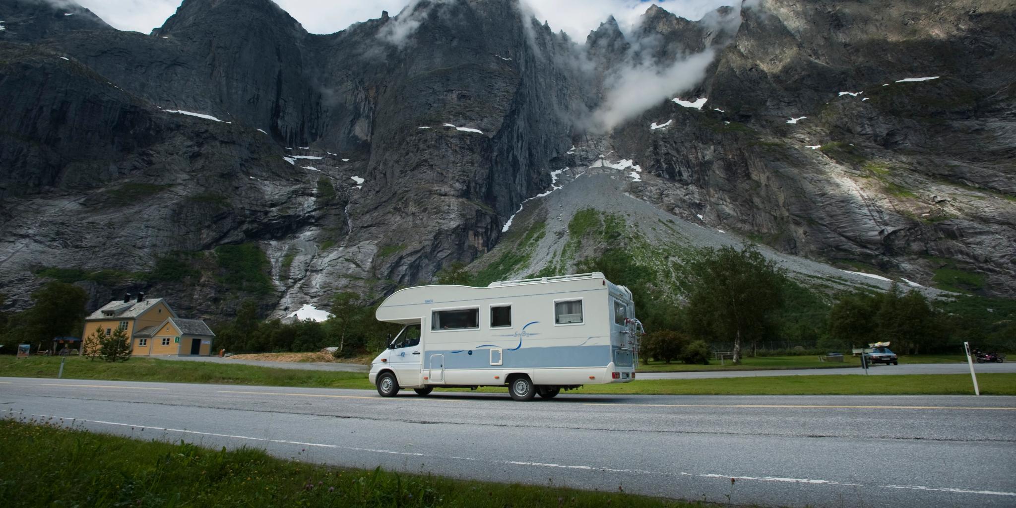 A caravan passing the Troll Wall in Norway