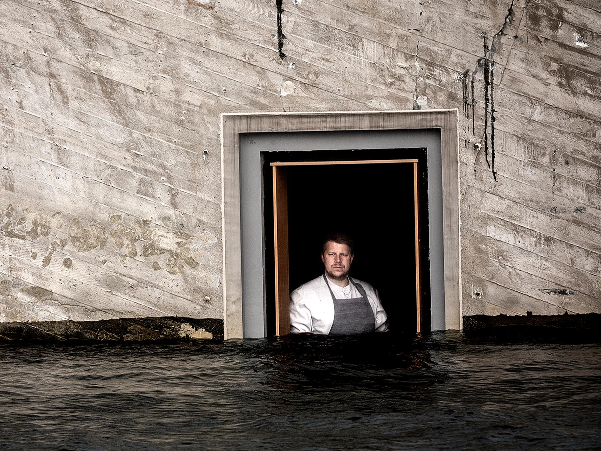 Chef Nicolai Ellitsgaard is looking out of the window at the partially submerged restaurant Under in Lindesnes, Southern Norway
