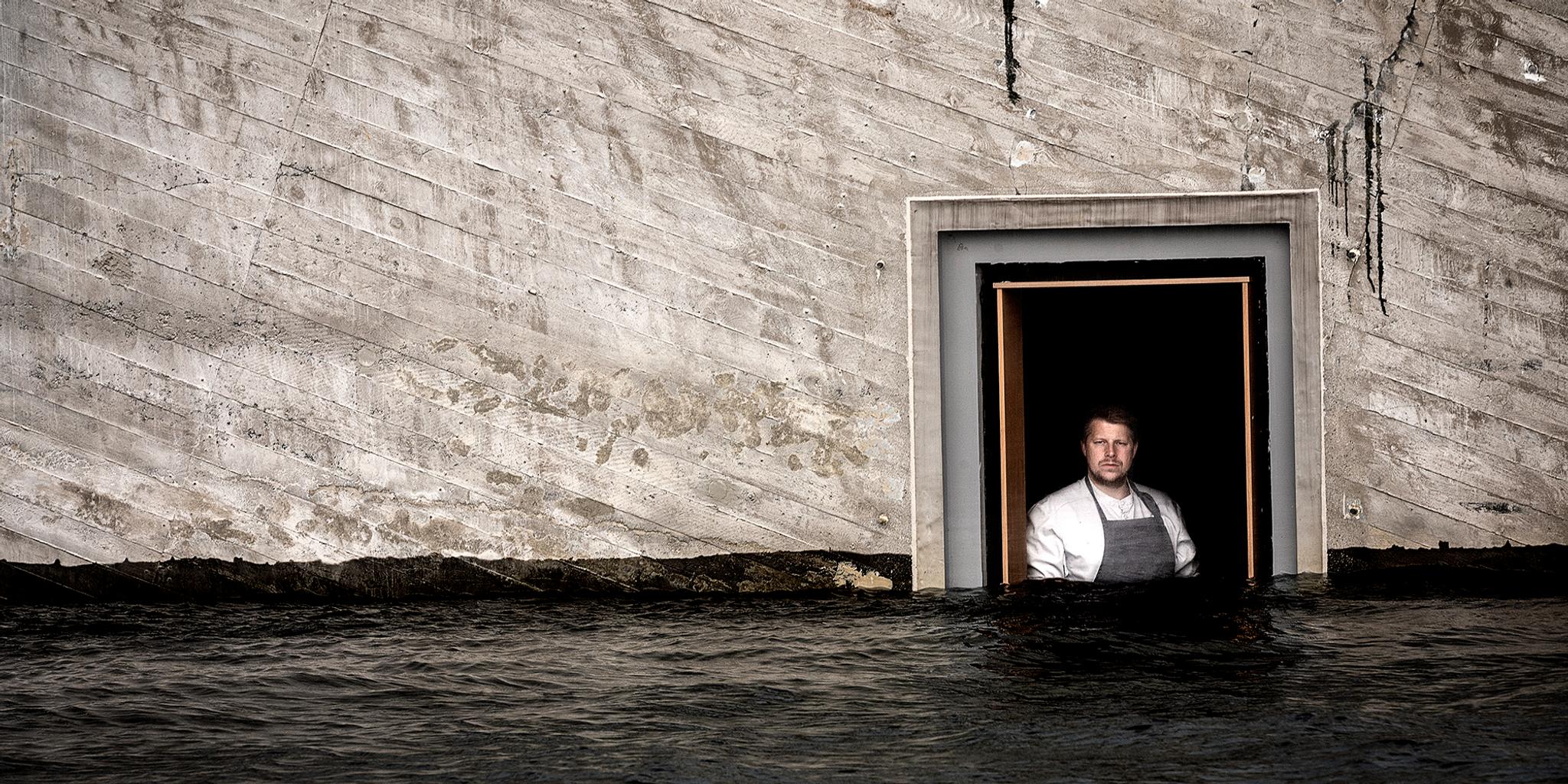 Chef Nicolai Ellitsgaard is looking out of the window at the partially submerged restaurant Under in Lindesnes, Southern Norway