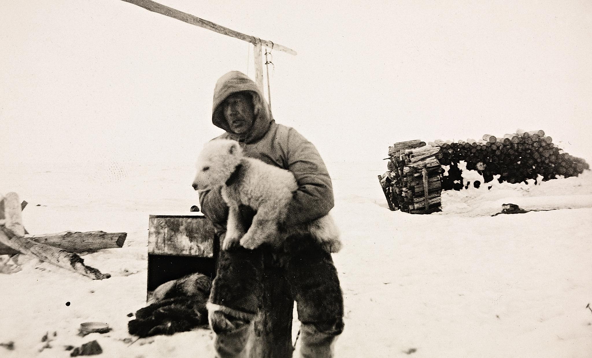 Roald Amundsen in a snowy landscape with his dog in Ajon, Russia