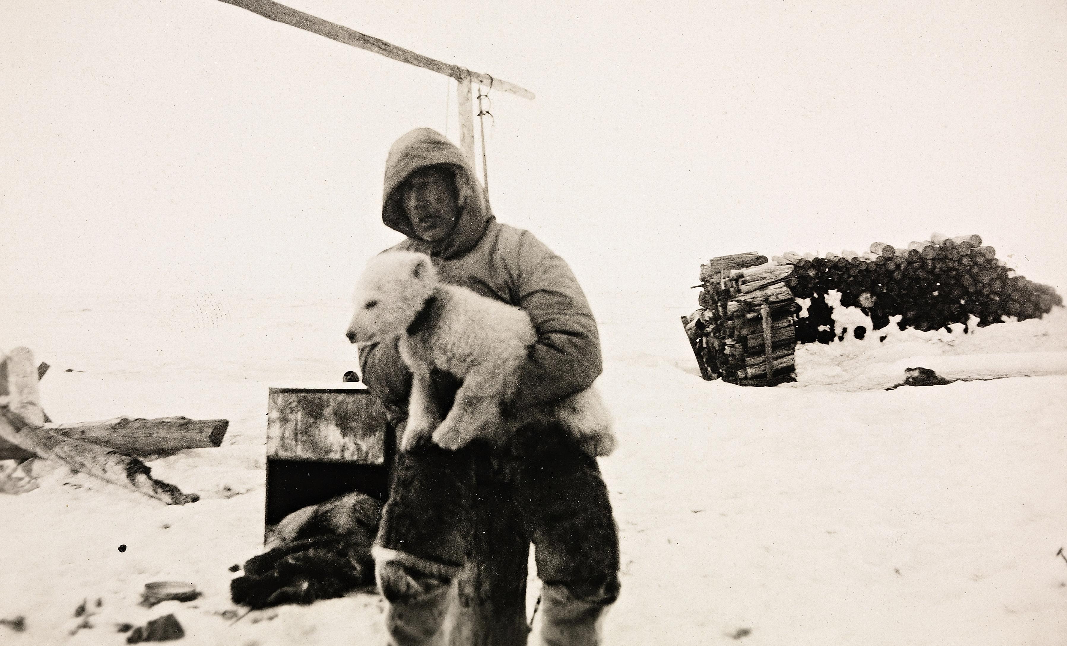 Roald Amundsen in a snowy landscape with his dog in Ajon, Russia