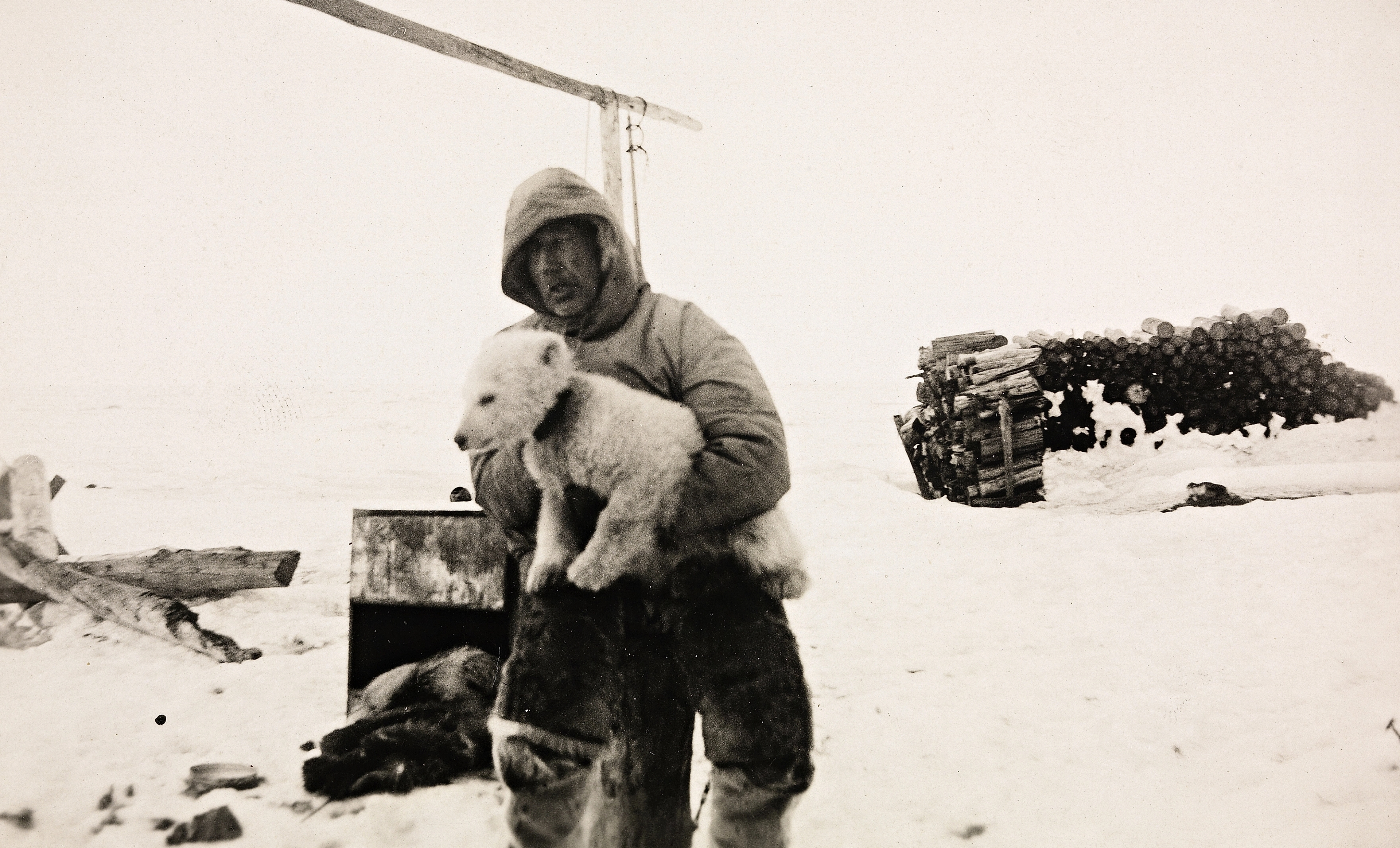 Roald Amundsen in a snowy landscape with his dog in Ajon, Russia