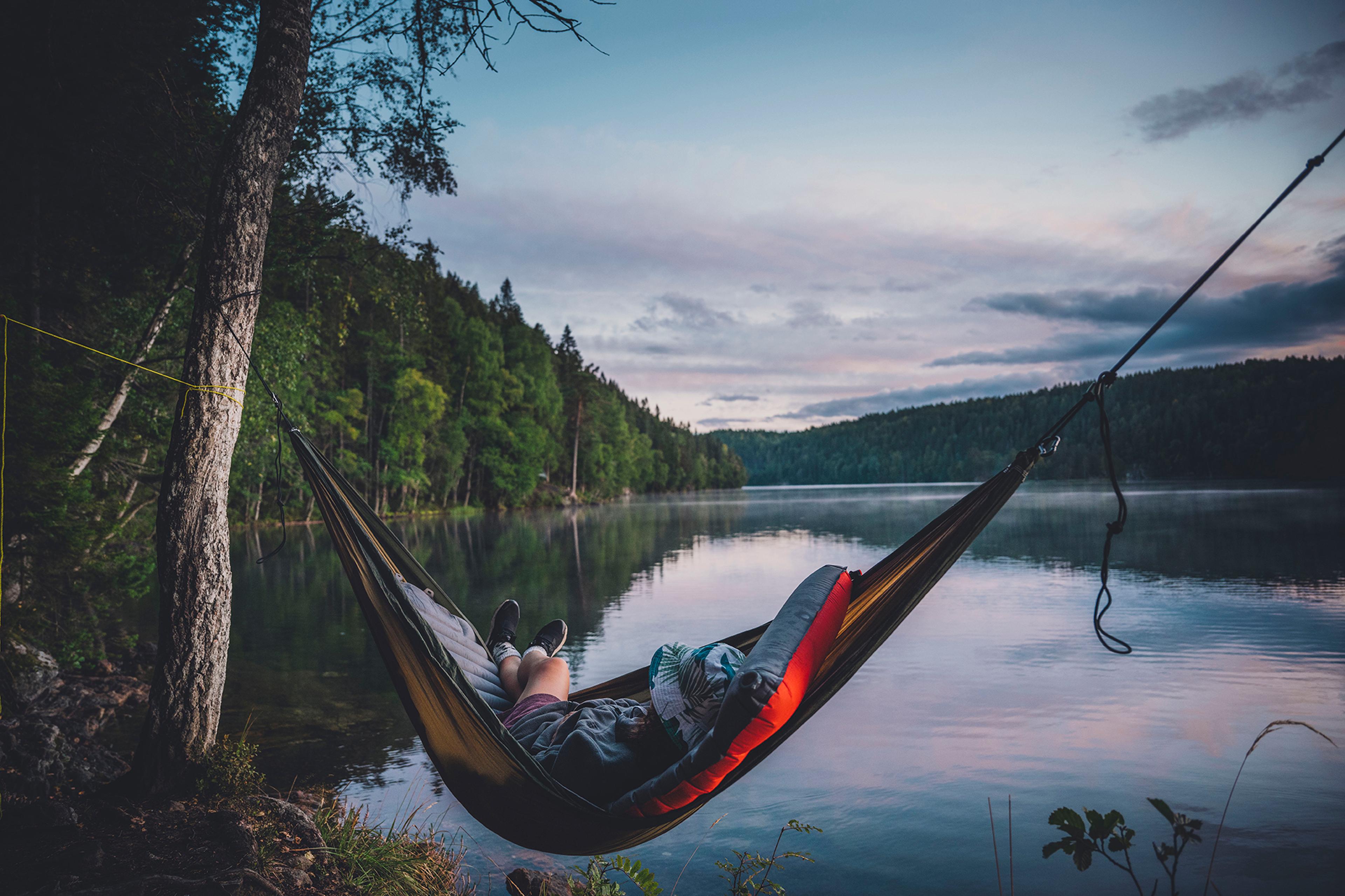 A person in a hammock in Østmarka forest in Oslo, Eastern Norway