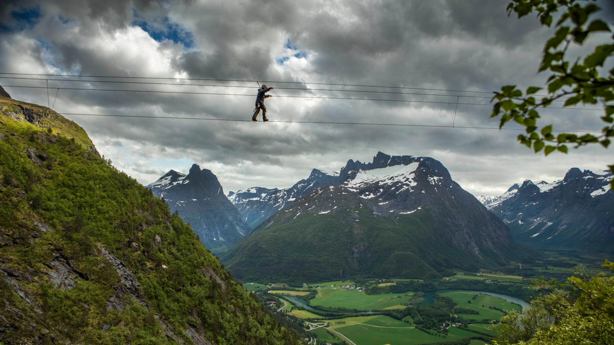 A person crossing the Romsdalsstigen via ferrata in Åndalsnes in Northwest, Fjord Norway