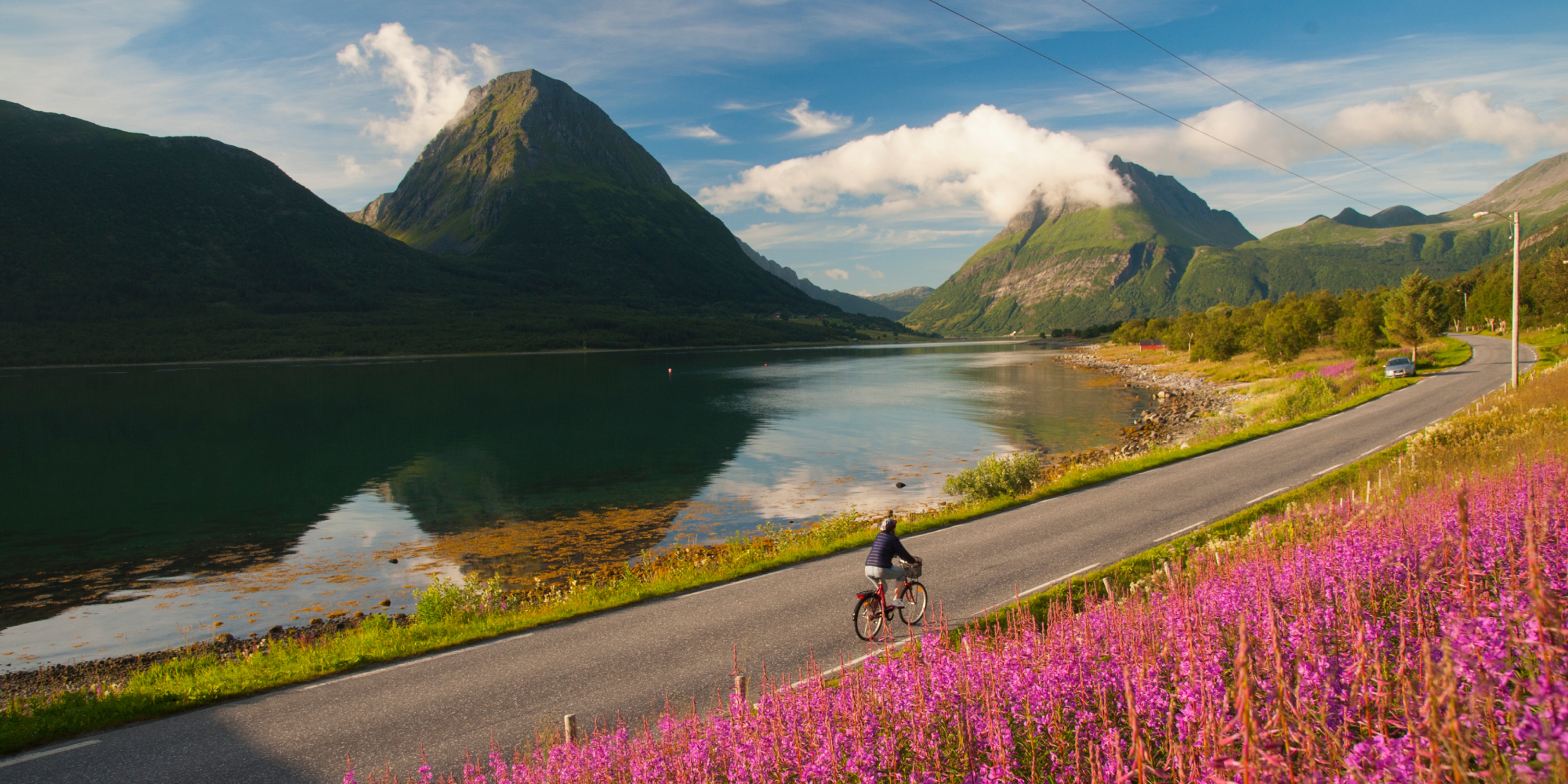 Woman biking in Lurøy, Aldersund