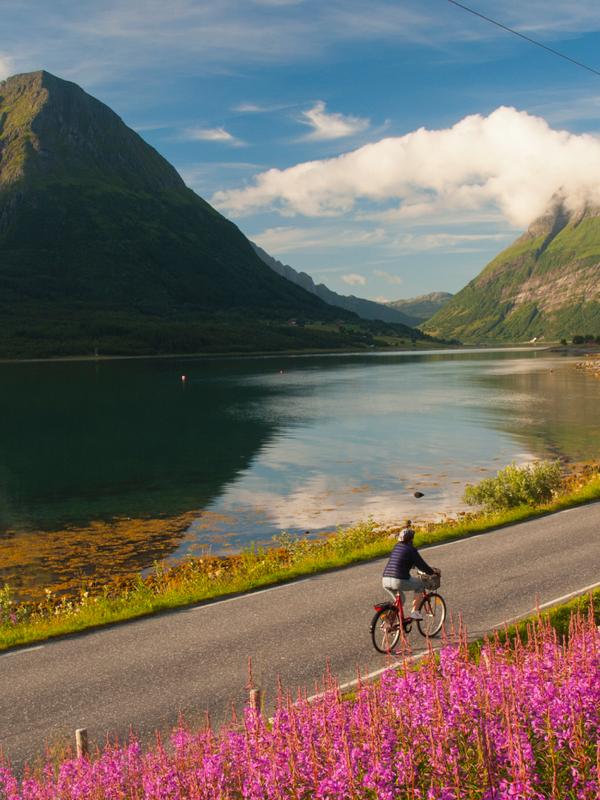Woman biking in Lurøy, Aldersund