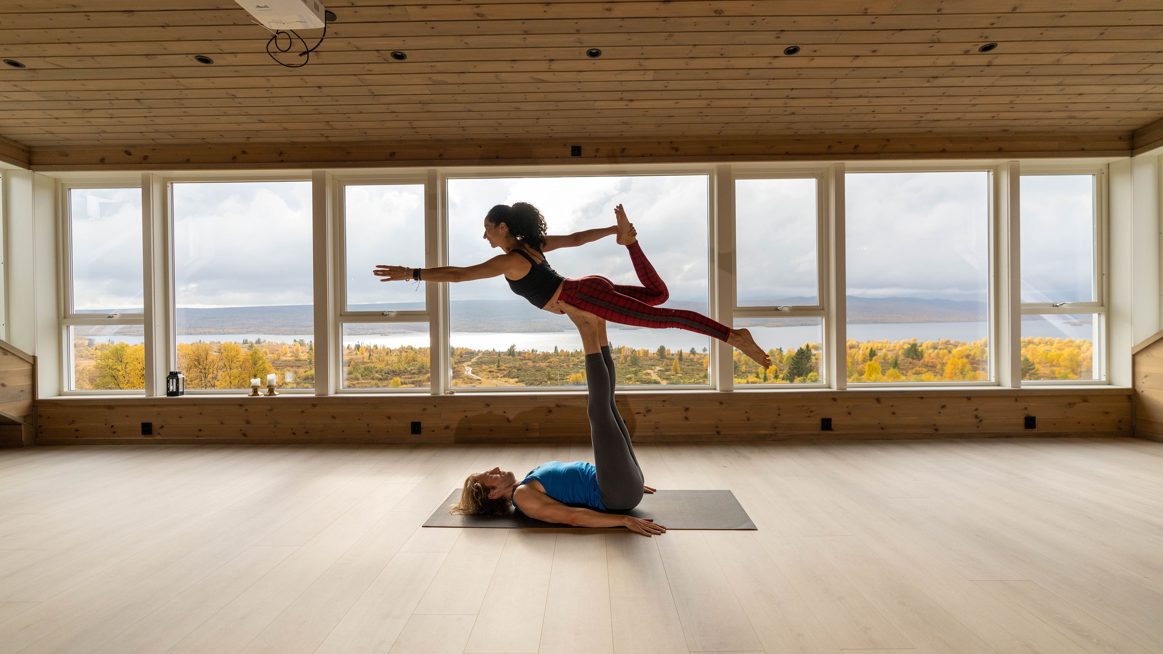 A man and a woman practicing yoga at Nøsen yoga and mountain hotel in Eastern Norway