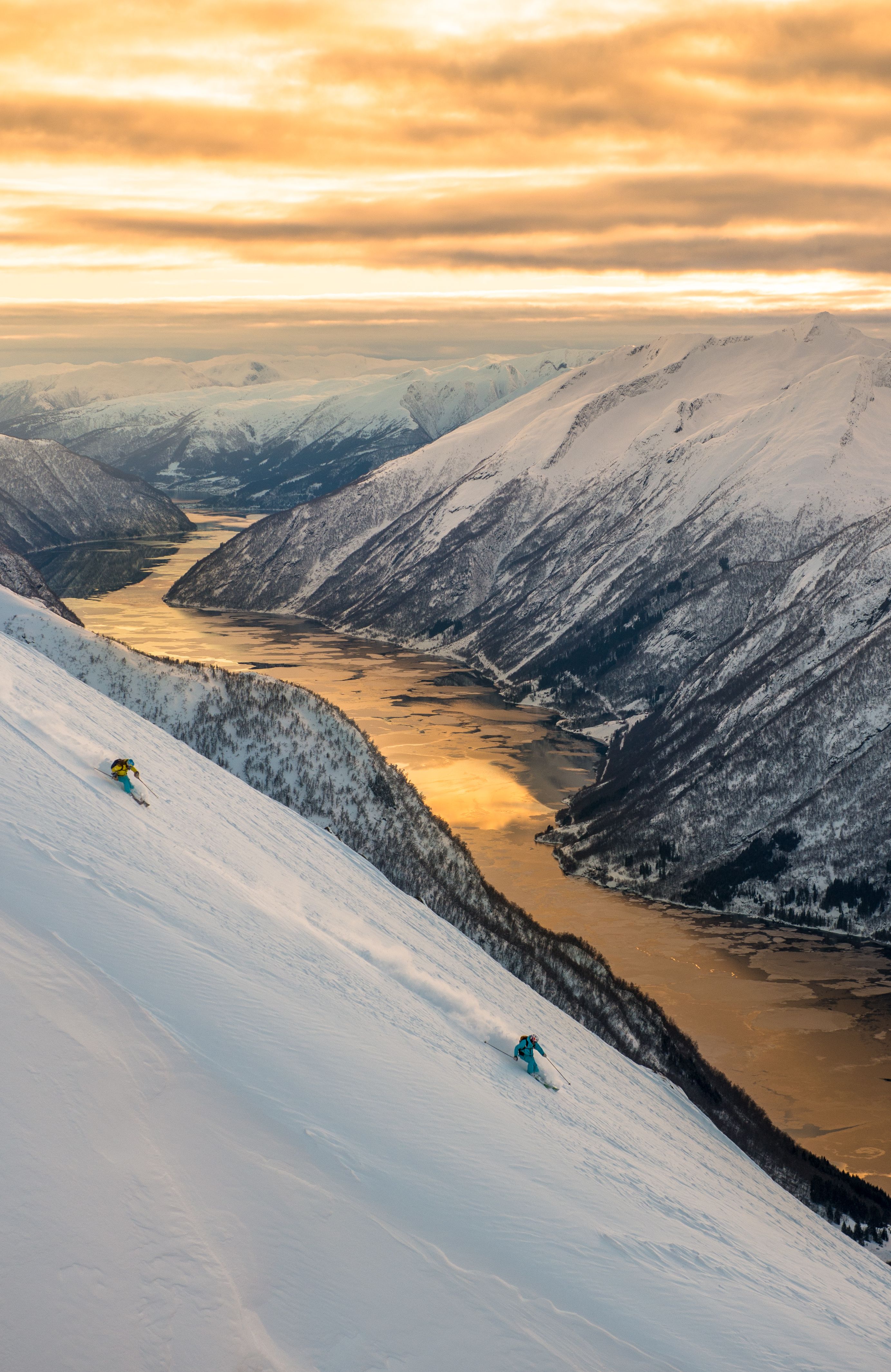 Ski tourers on their way down the mountain towards the fjord in Sogndal, Fjord Norway