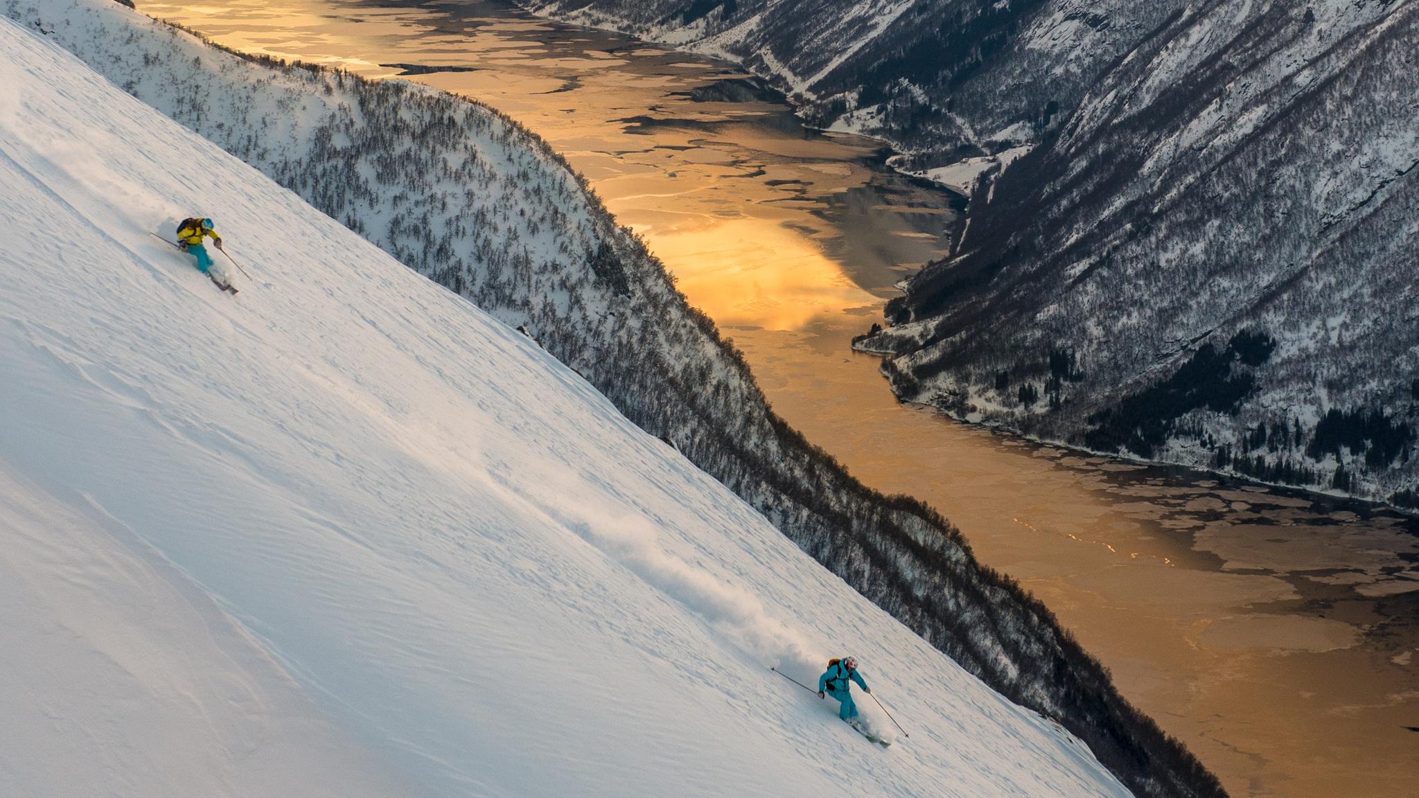 Ski tourers on their way down the mountain towards the fjord in Sogndal, Fjord Norway