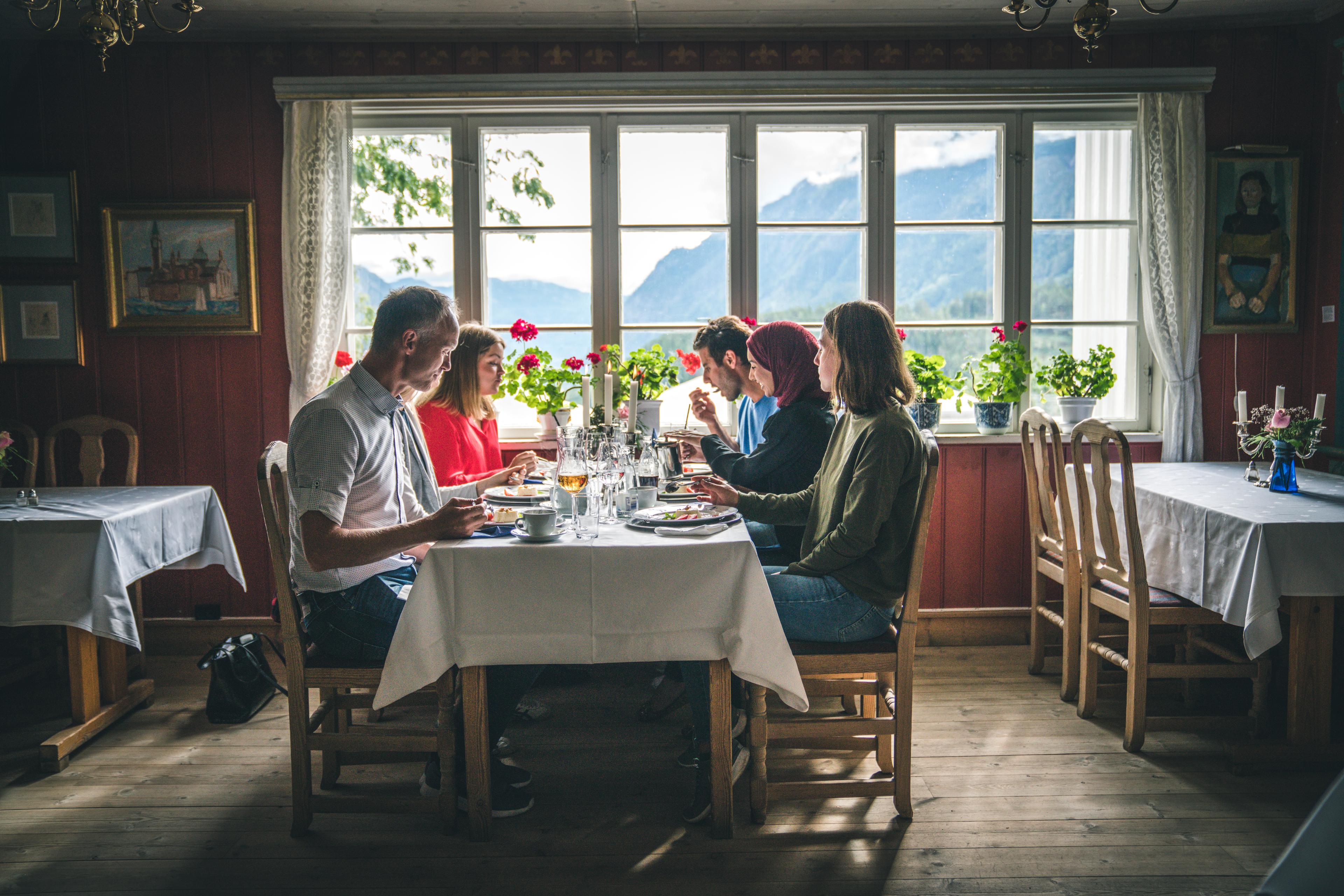 A group of people eating dinner at Nutheim Gjestgiveri in Telemark, Eastern Norway