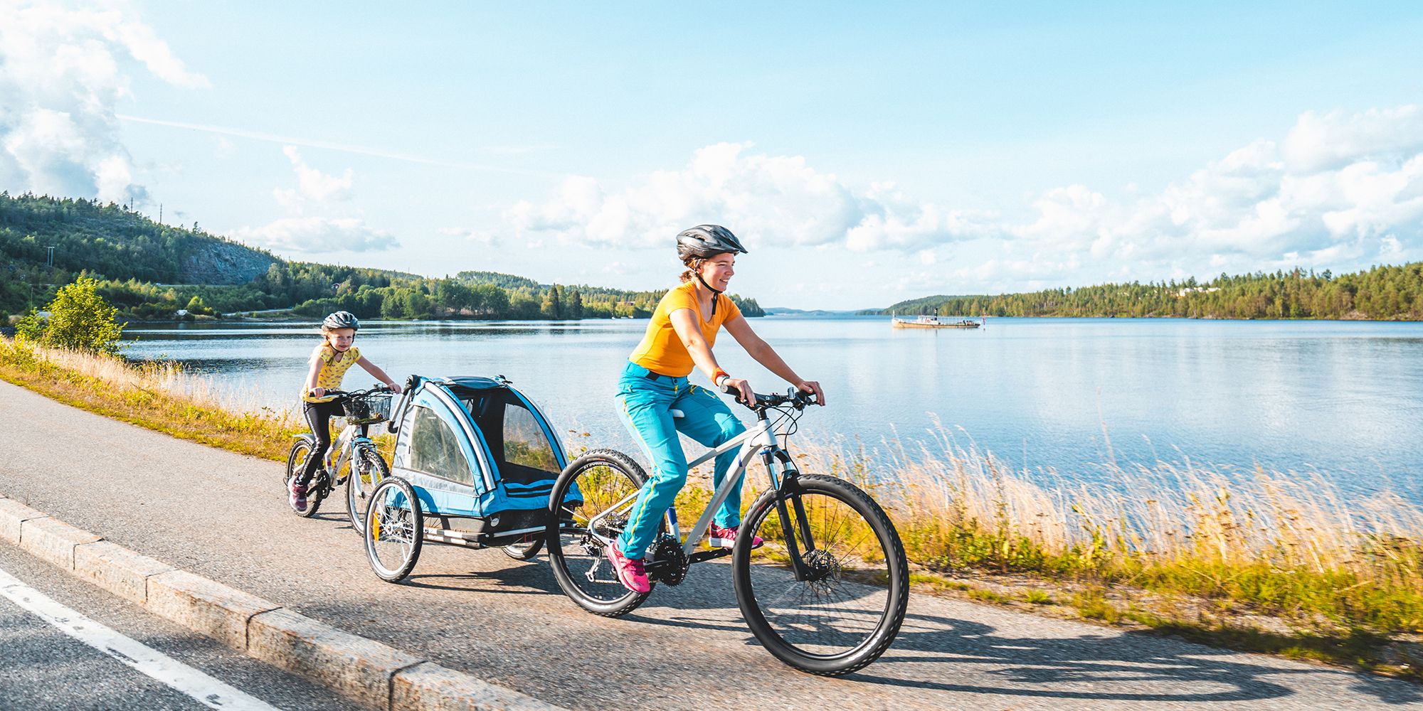 People cycling along the lake in Inner Østfold, Eastern Norway