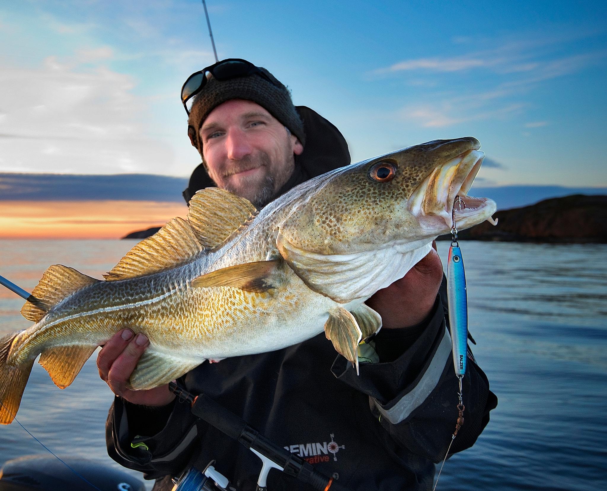 A man holding a fish at Fosen, Trøndelag, Norway.