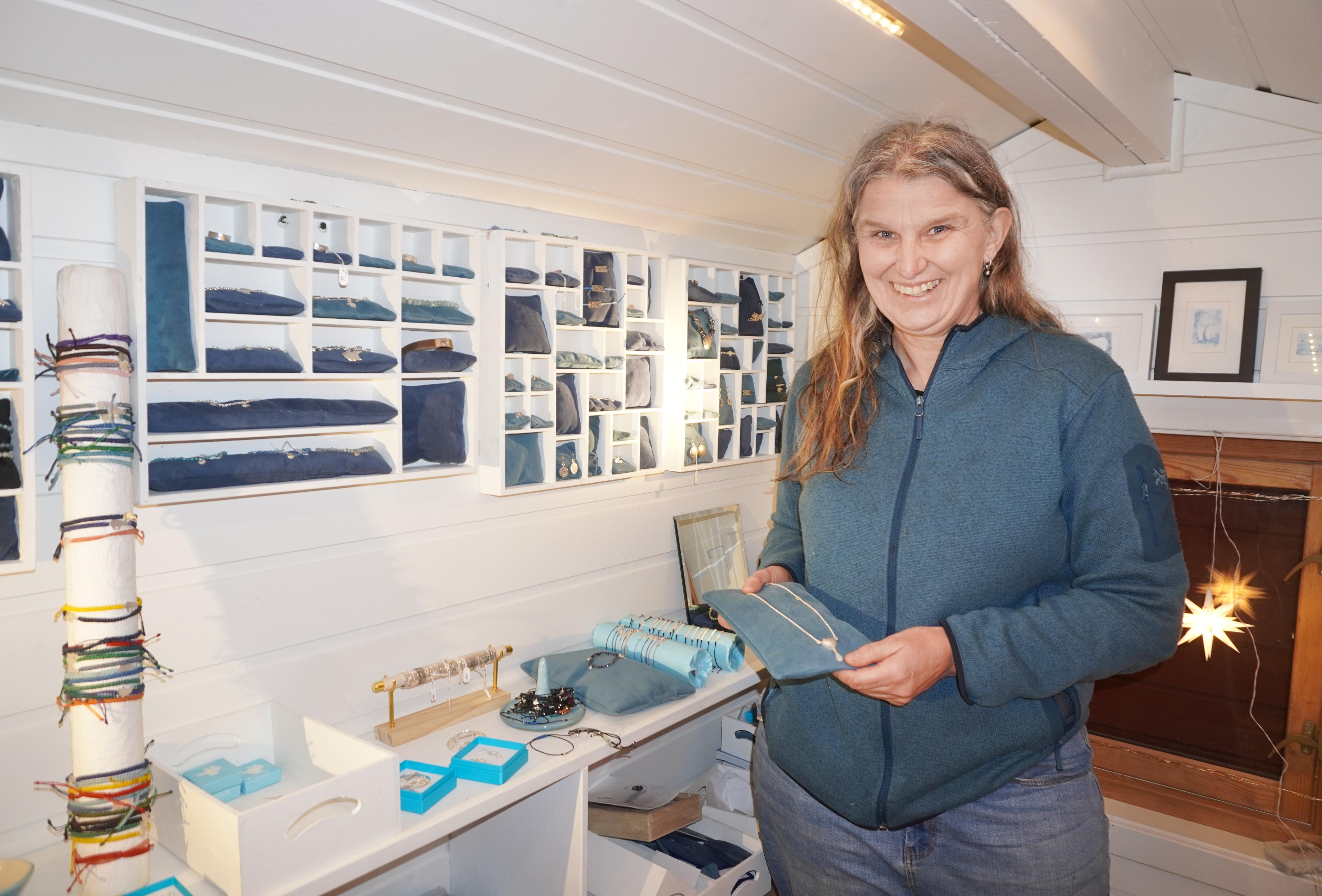 Female goldsmith and sailor in her small shop