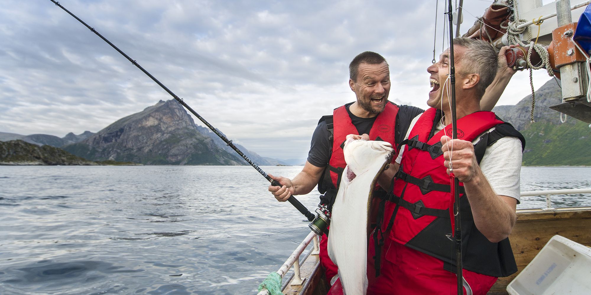 Two men in a boat sea fishing in Tromsø in Northern Norway