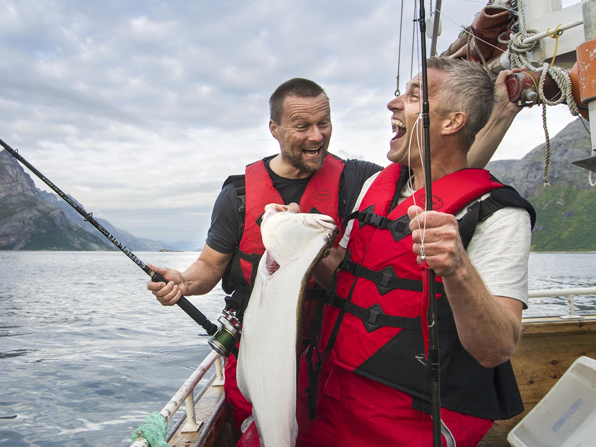 Two men in a boat sea fishing in Tromsø in Northern Norway