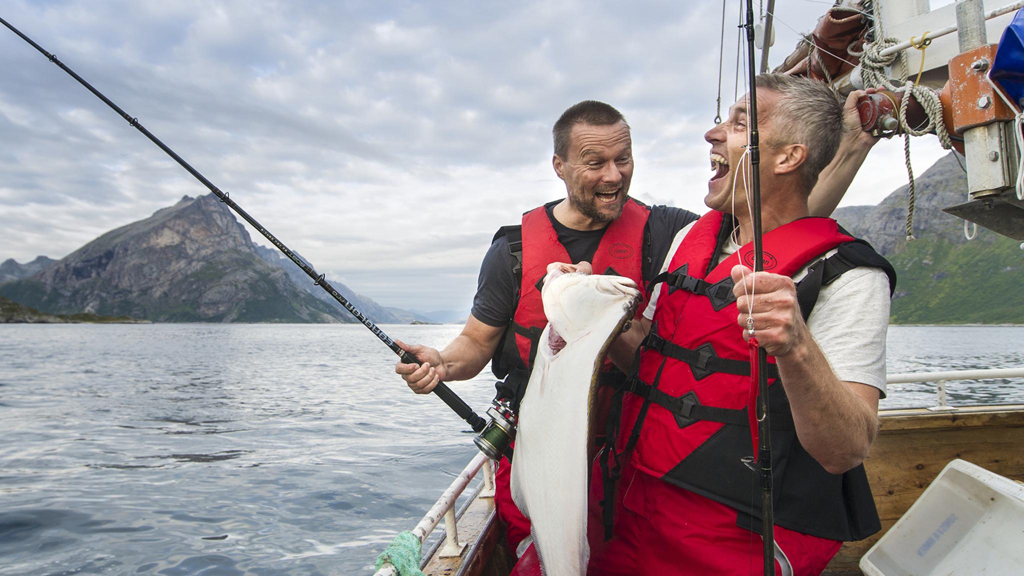 Two men fishing in boat in Tromsø