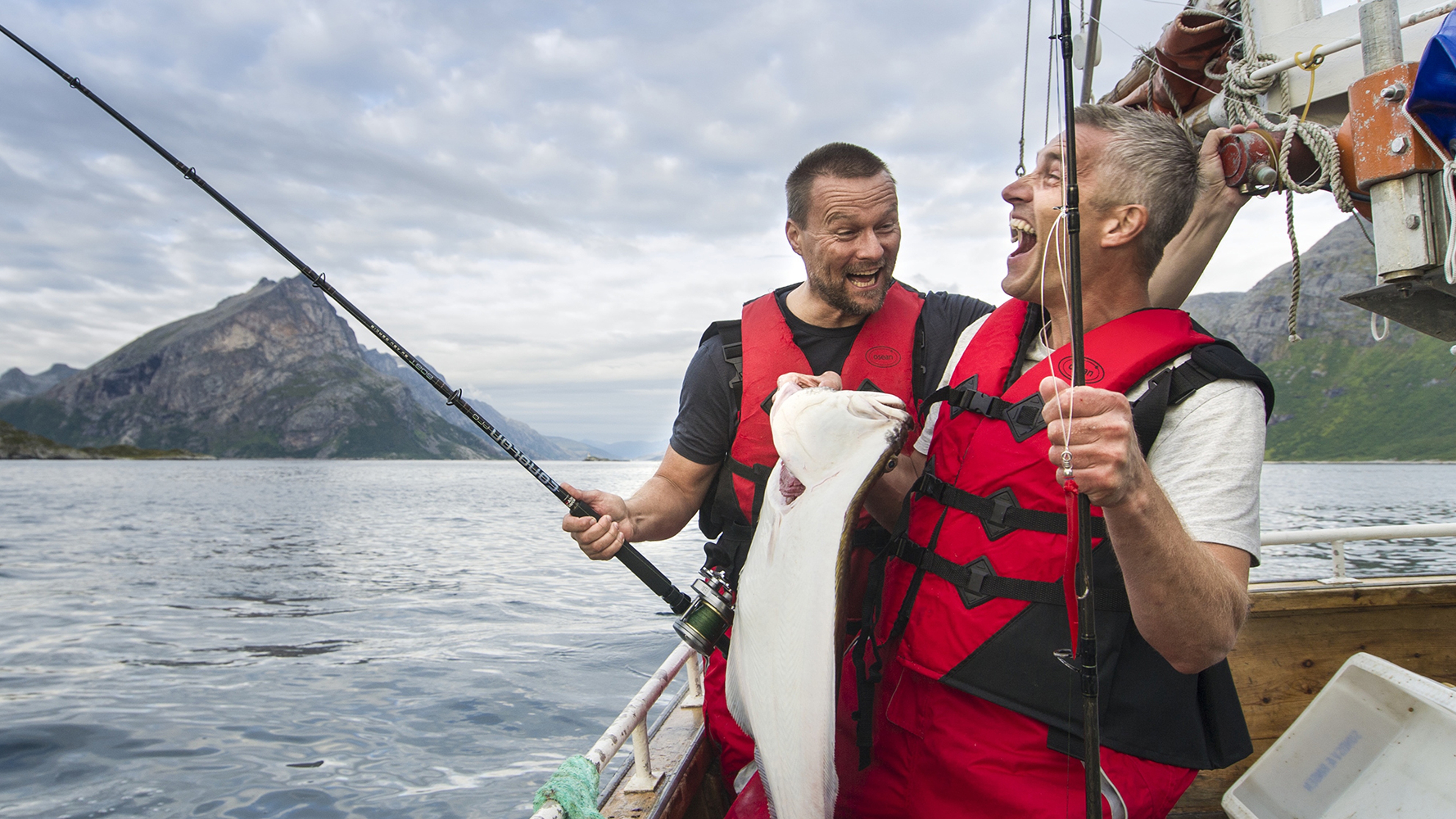 Two men fishing in boat in Tromsø