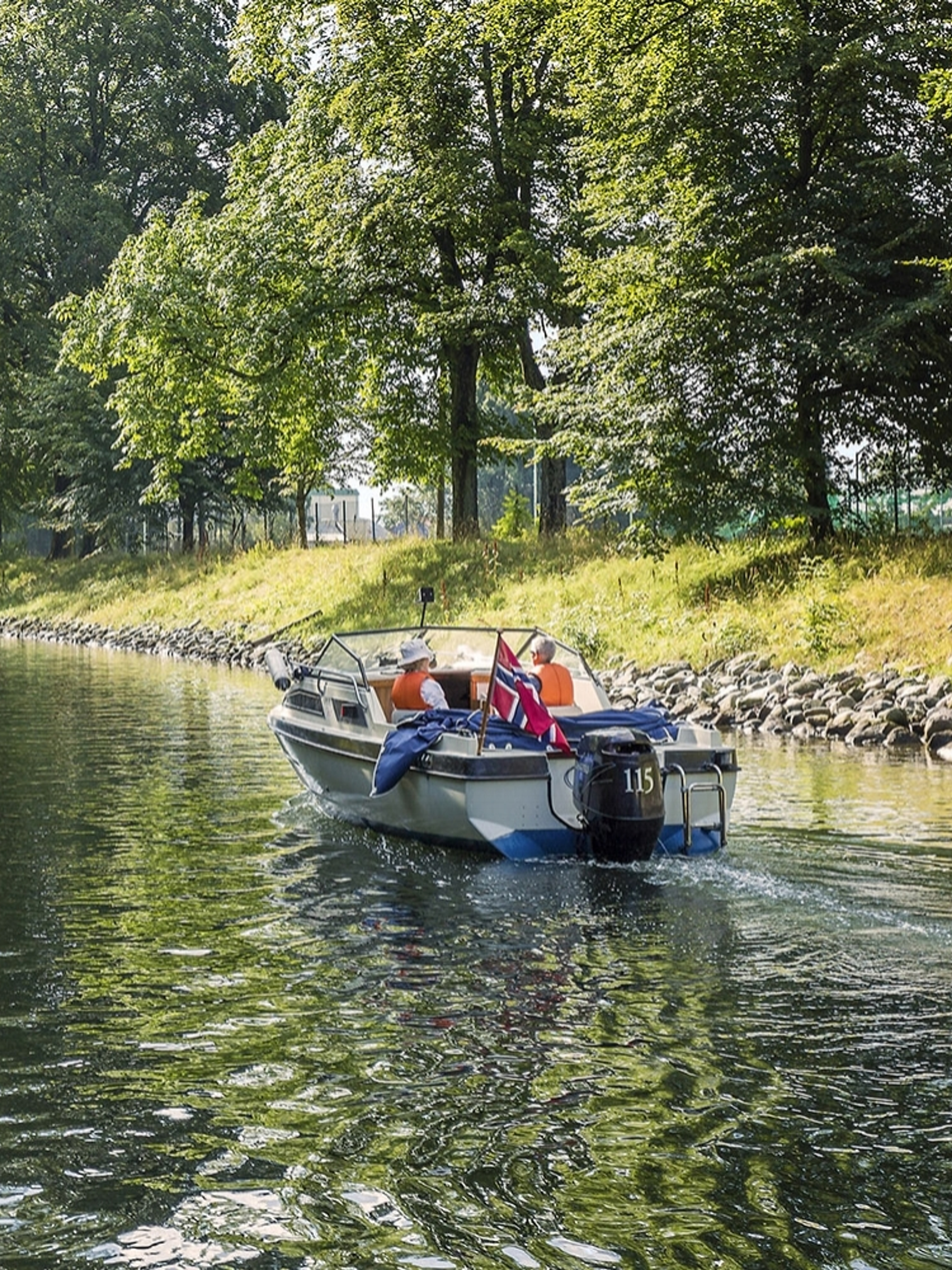 A boat drives in a leisurely pace in the Hortenkanalen canal in Horten in Vestfold, Eastern Norway