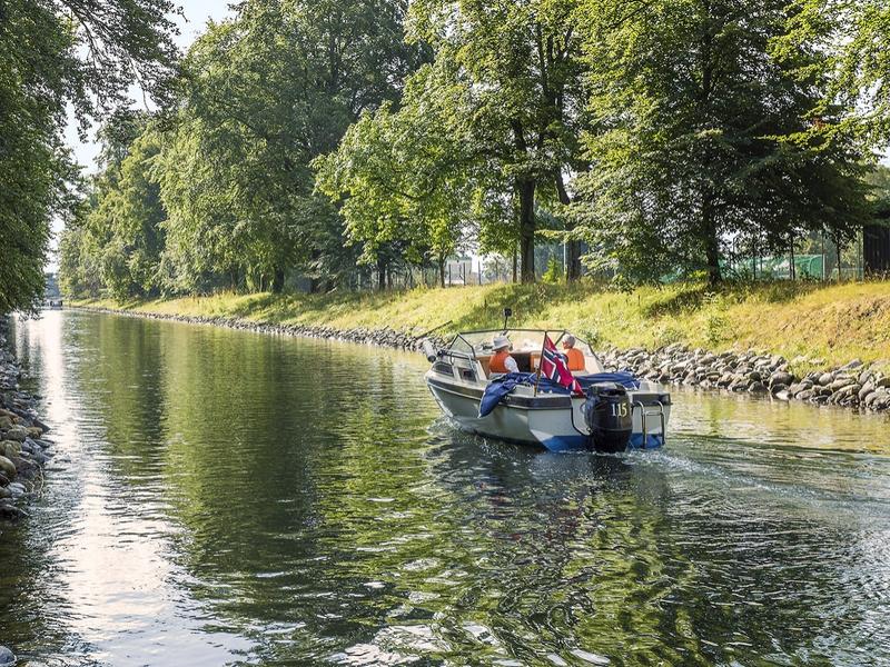 A boat drives in a leisurely pace in the Hortenkanalen canal in Horten in Vestfold, Eastern Norway