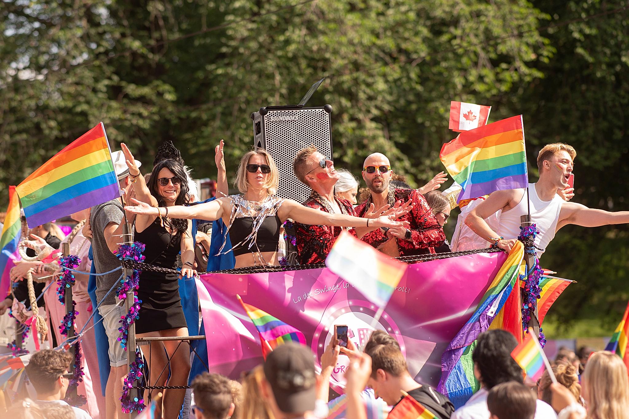 People celebrating Pride on a truck at the Oslo Pride parade, 2023