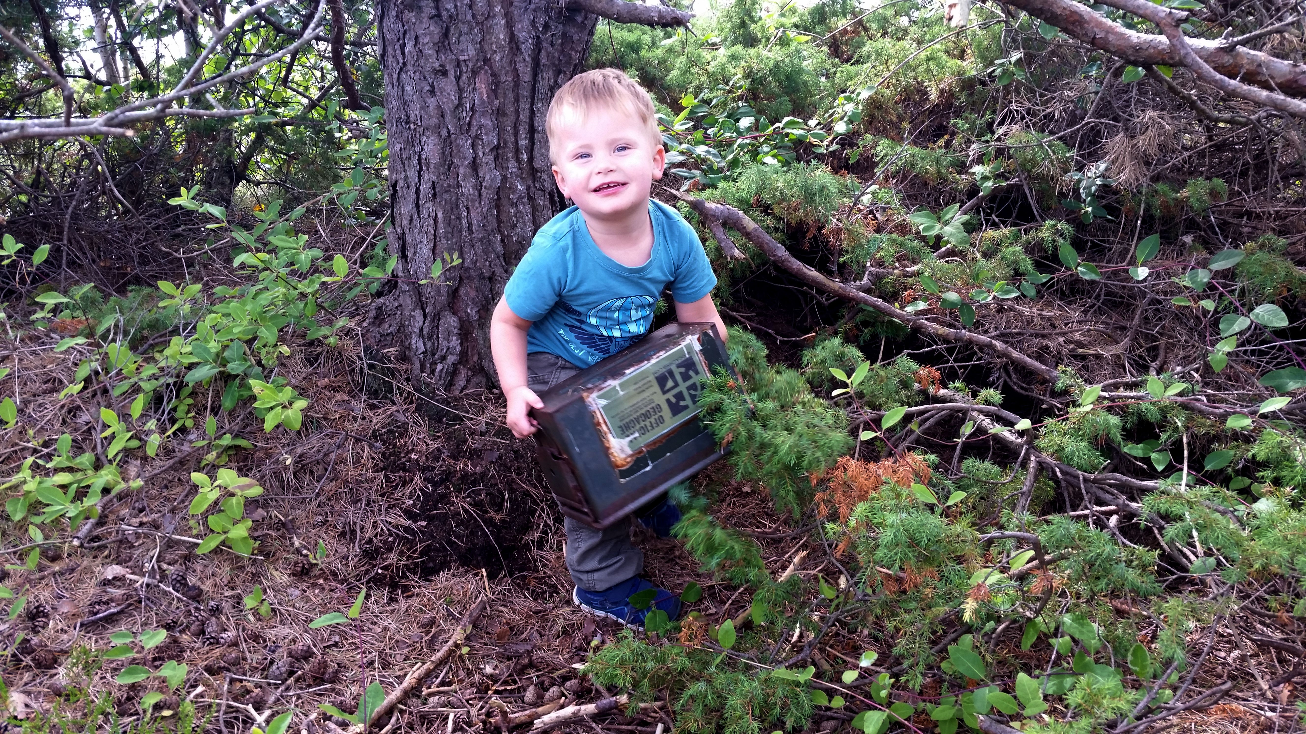 A boy geoaching next to a tree in Lyngor in Southern Norway