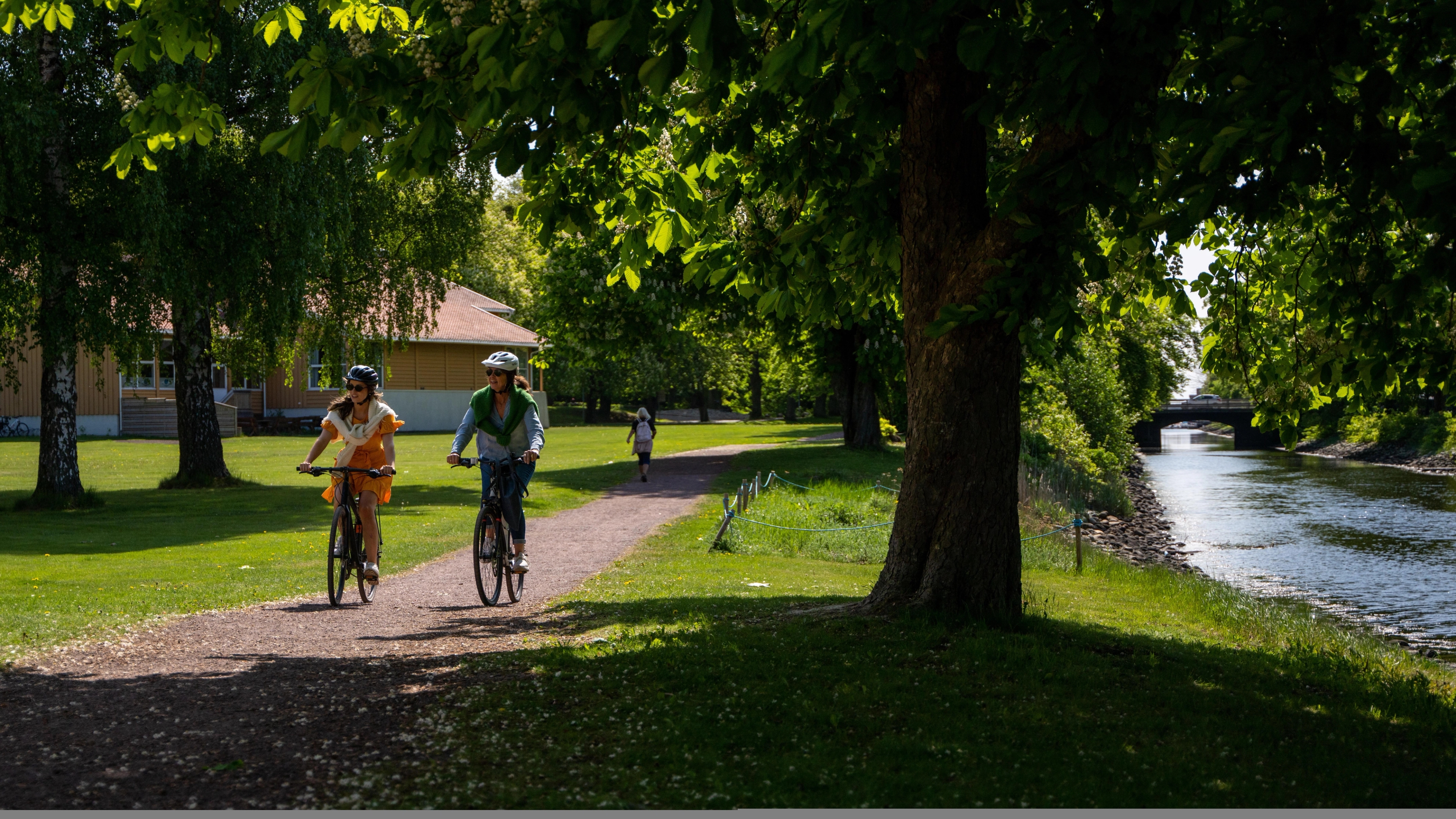 Two women biking along the Horten channel, in Horten