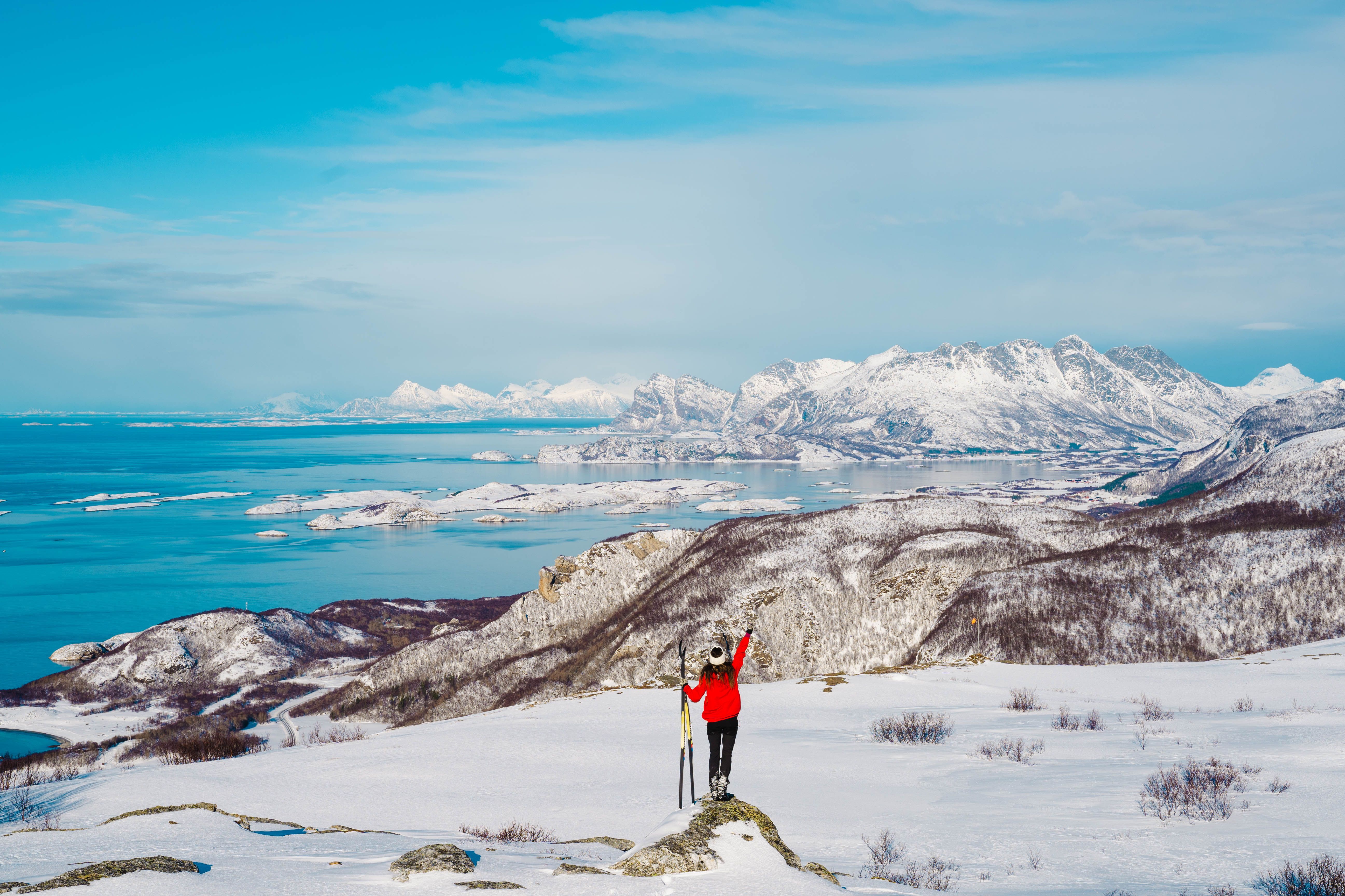 Girl cross country skiing on a snowy hill in Bodø with a beautiful view, Northern Norway