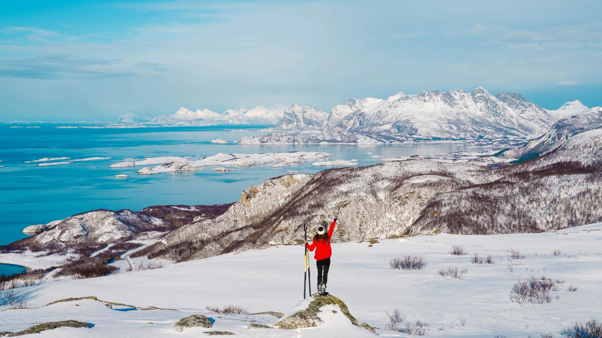 Girl cross country skiing on a snowy hill in Bodø with a beautiful view, Northern Norway