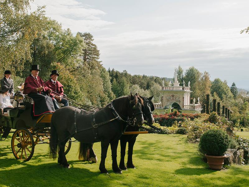Mensen in een paardenkoets in het Havlystparken-park in de cultuurbestemming Ramme Gård in Hvitsten aan het Oslofjord in Oost-Noorwegen