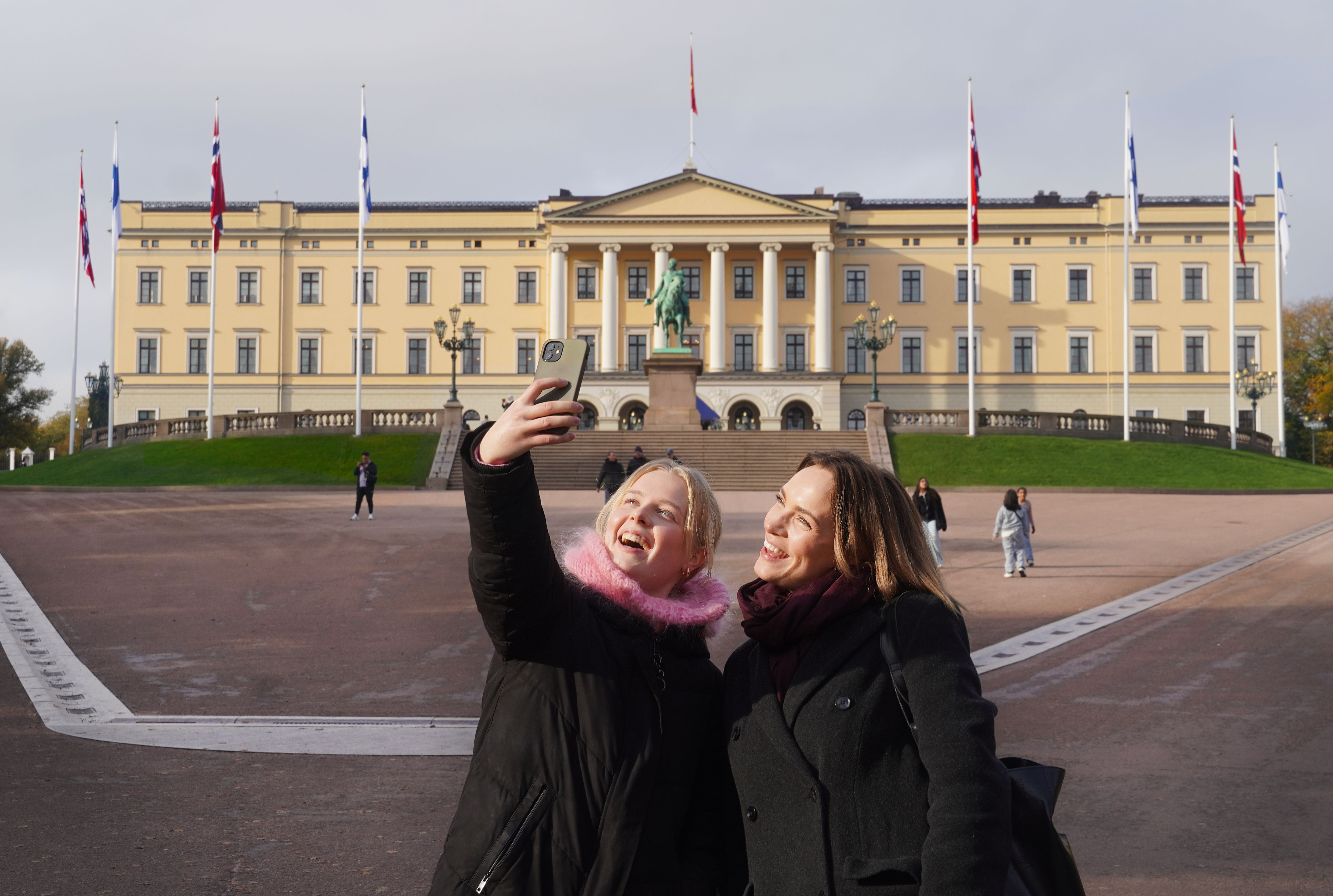 Two girls taking a selfie in front of the Norwegian castle in Oslo, Eastern Norway
