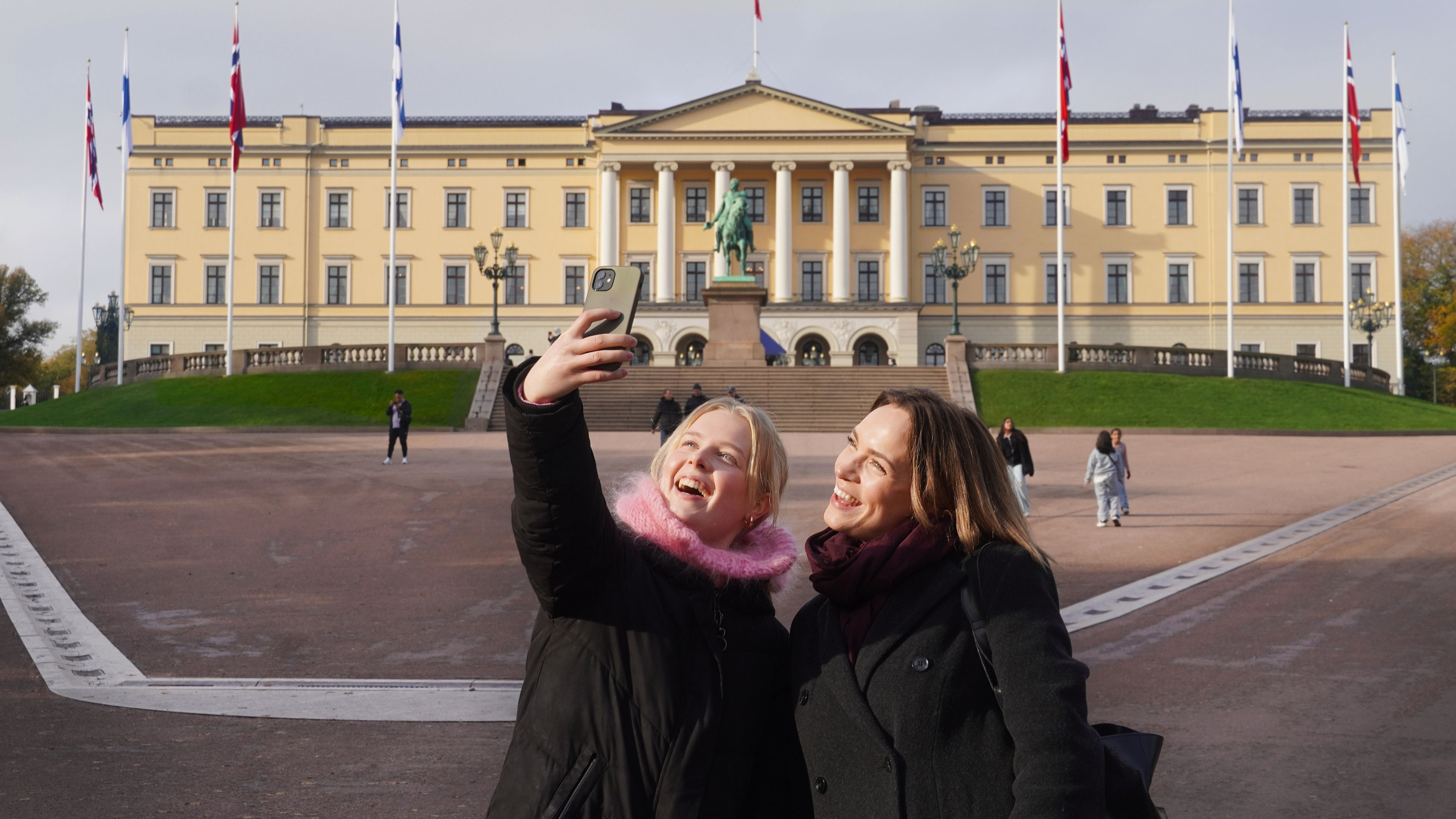 Two girls taking a selfie in front of the Norwegian castle in Oslo, Eastern Norway