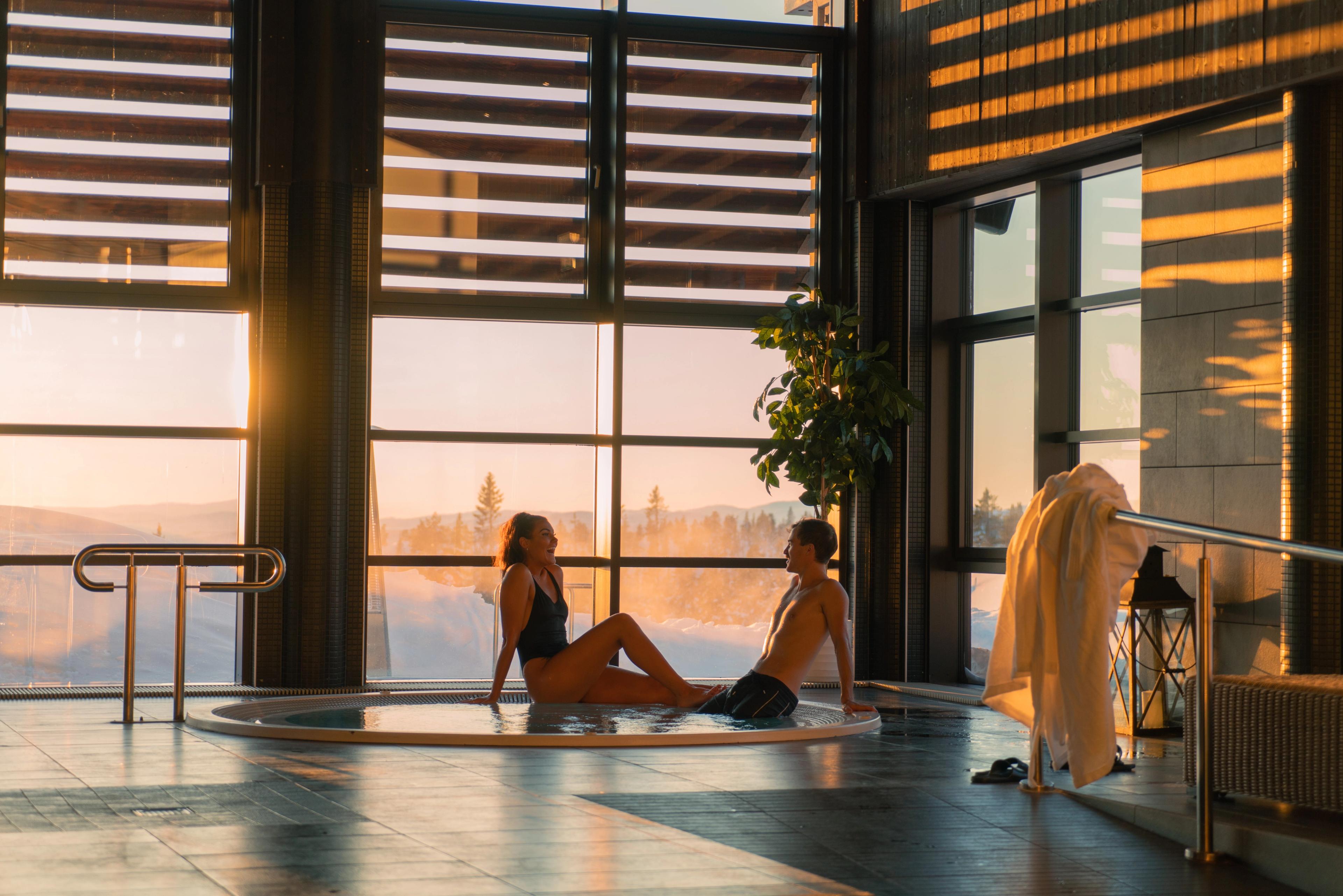 Two people sitting by a pool at Norefjell Ski and Spa