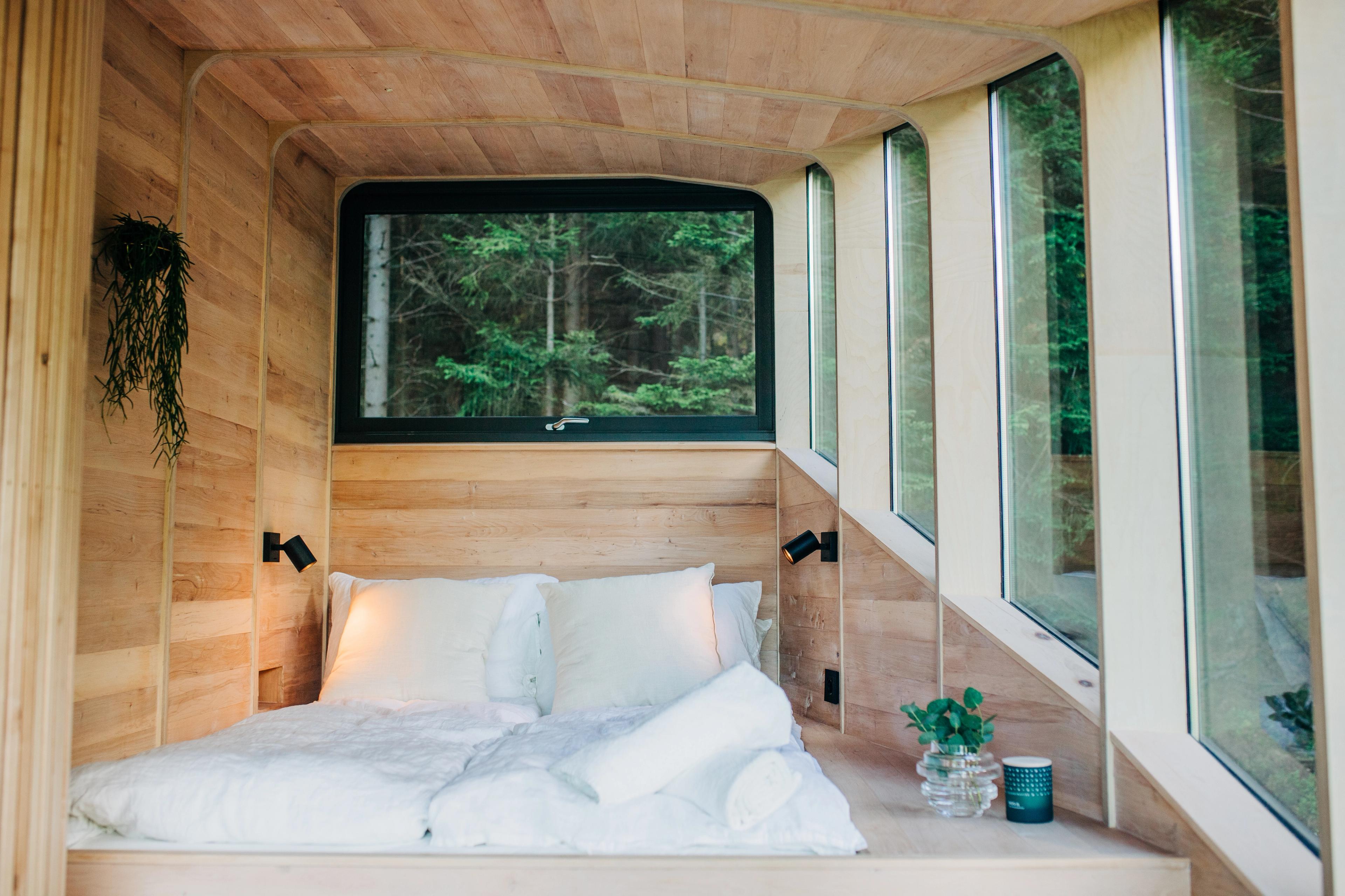 A bed inside the Woodnest treehouse in Odda