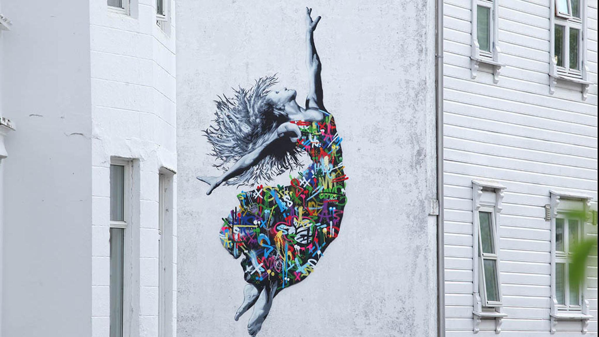 Street art of a woman in a colourful dress by Martin Whatson, Stavanger in Fjord Norway