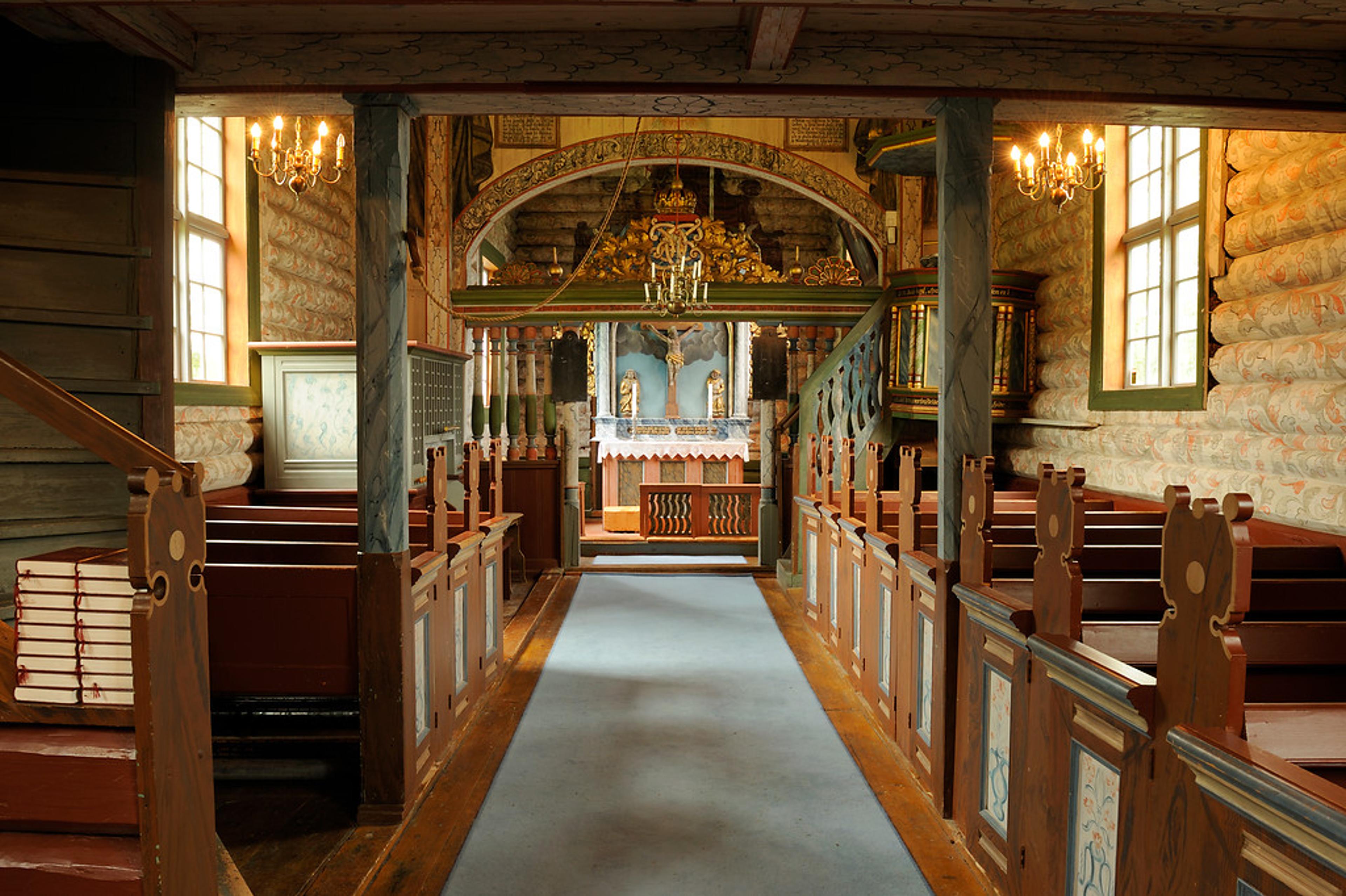 The inside of an old wooden church.