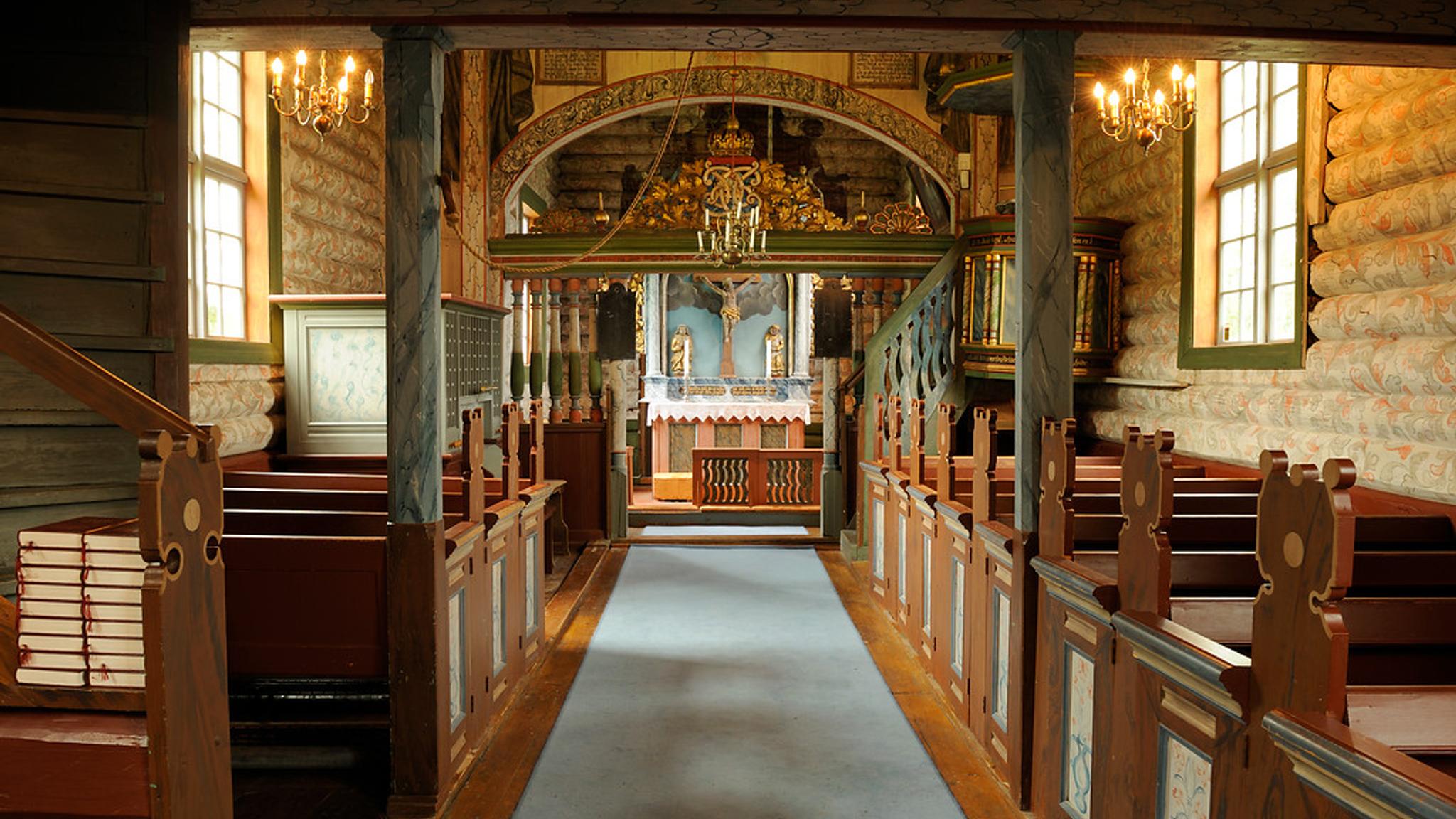 The inside of an old wooden church.
