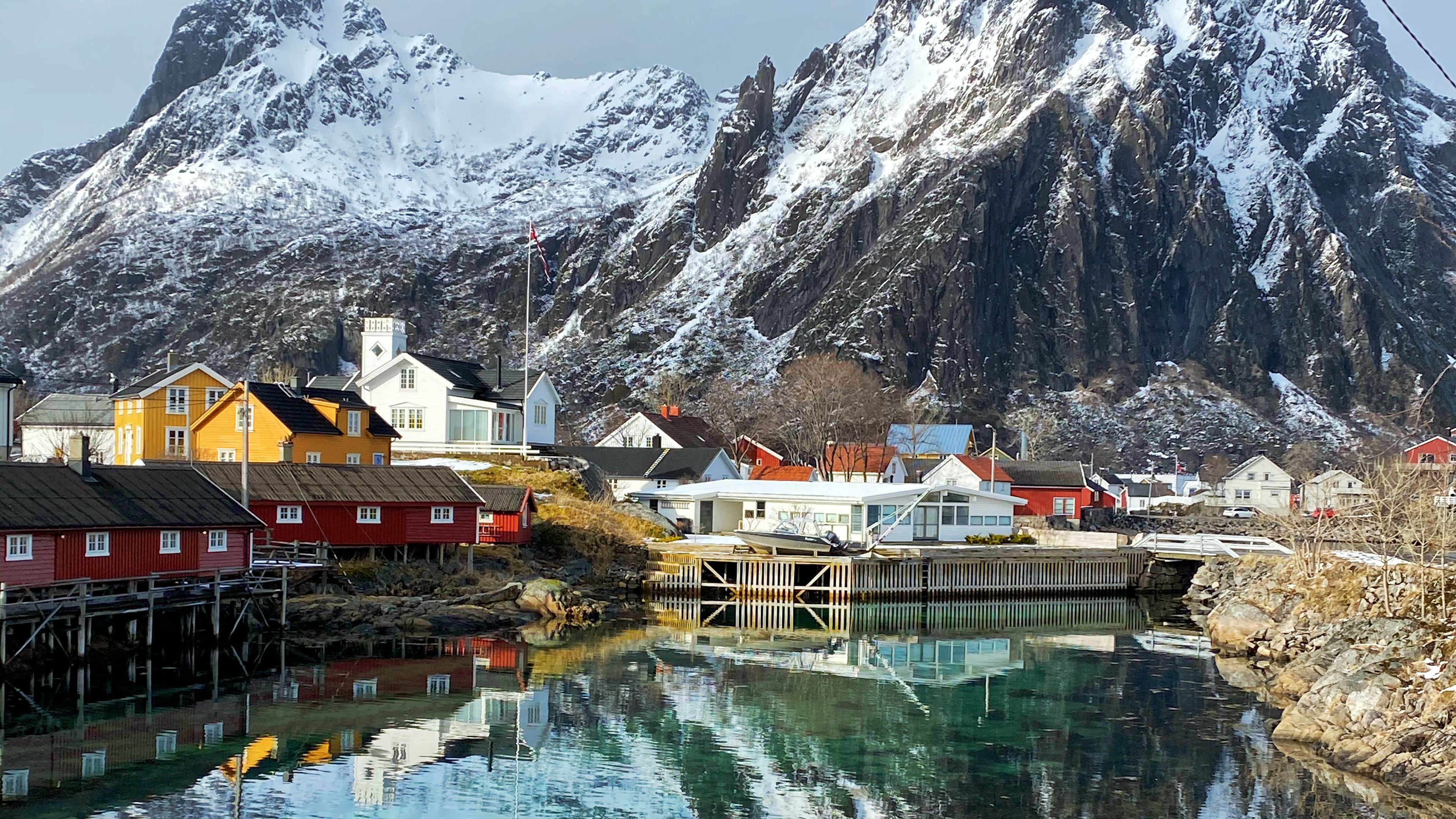 Houses beneath a big mountain by the sea in Svolvær