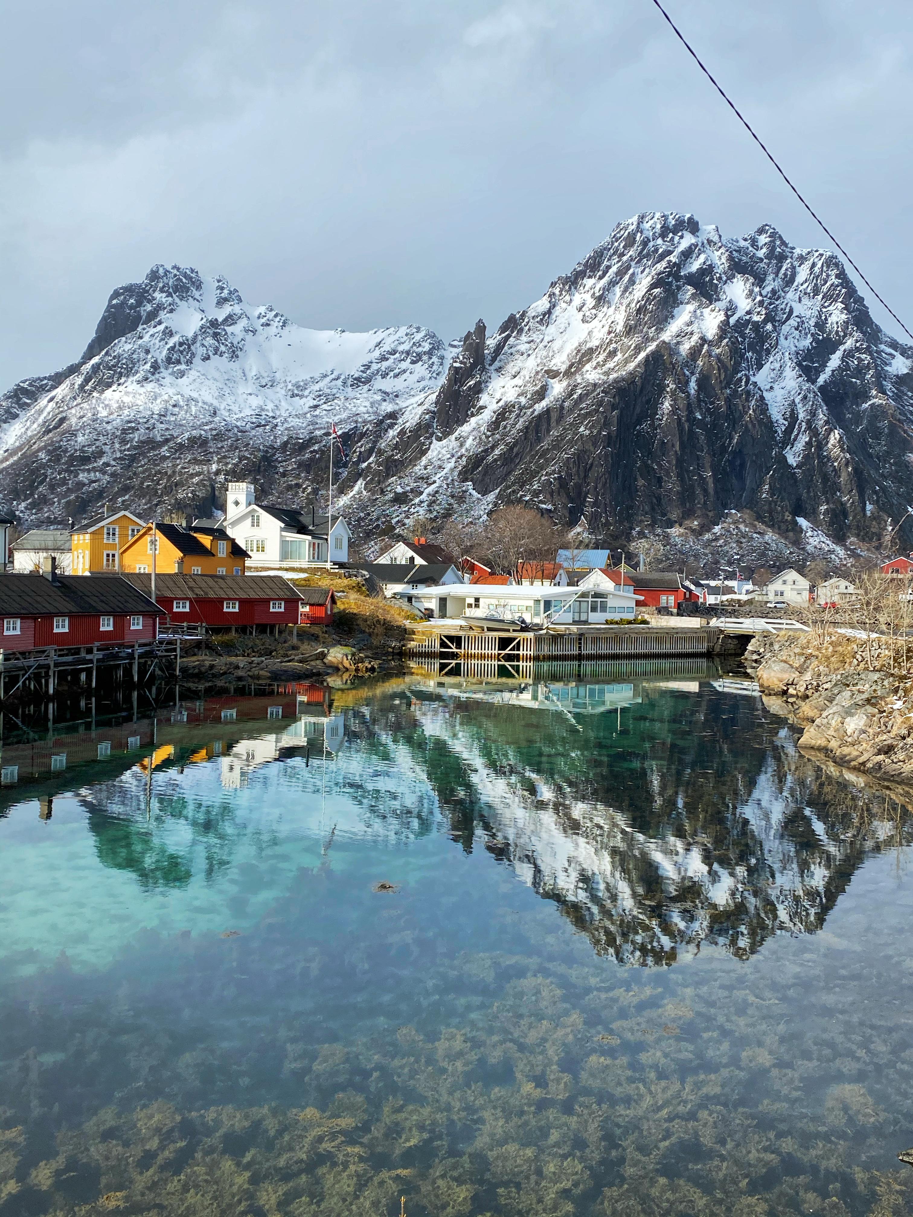 Houses beneath a big mountain by the sea in Svolvær