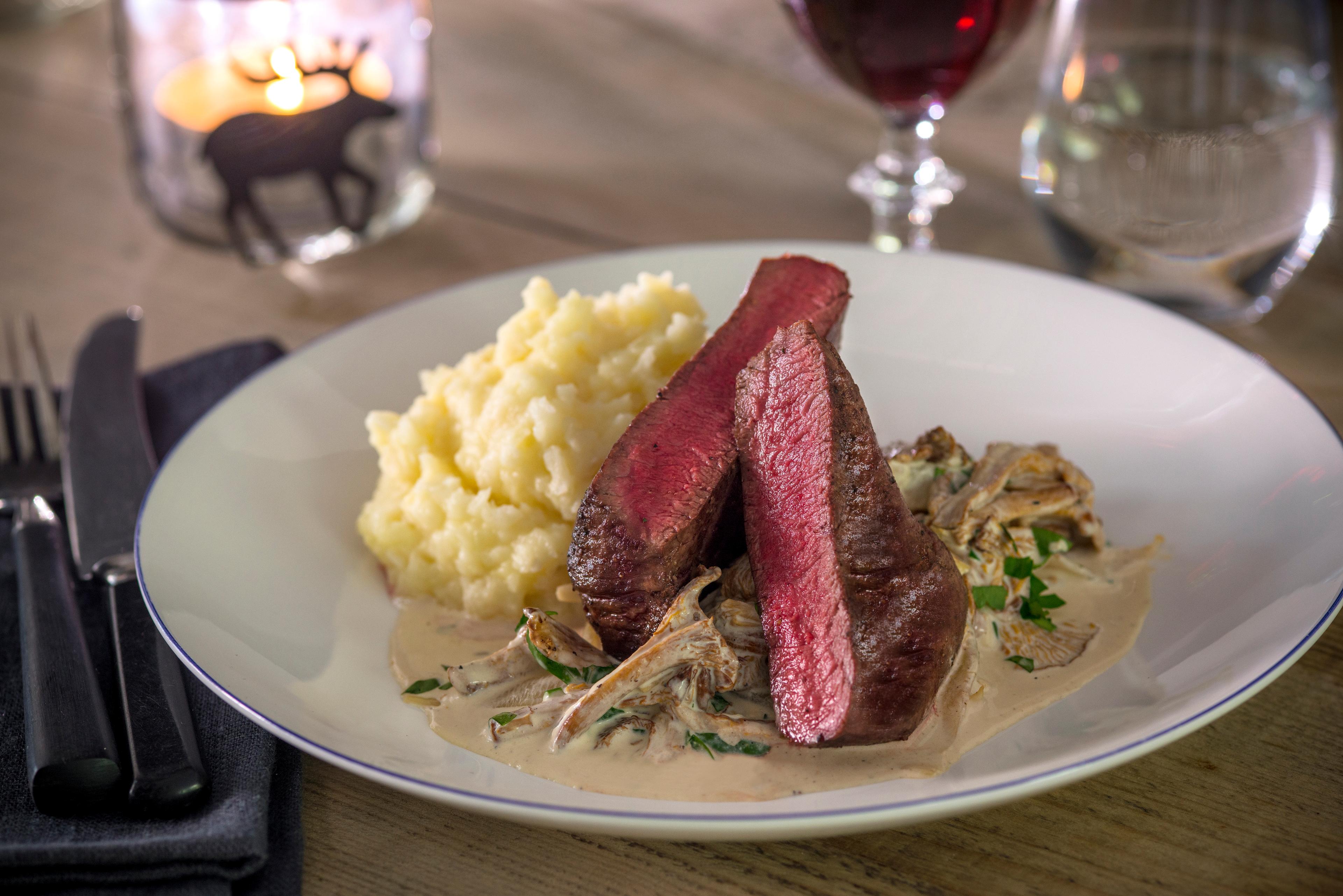 Meat and mushroom stew on a plate.