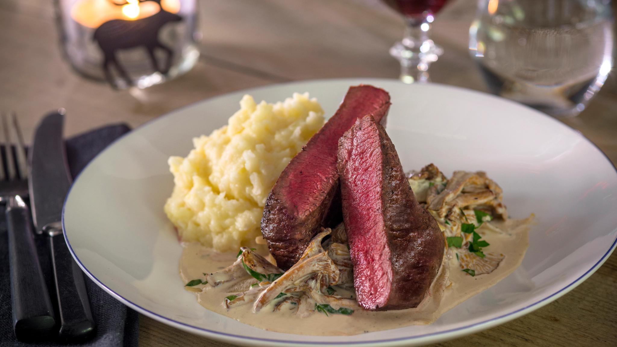 Meat and mushroom stew on a plate.