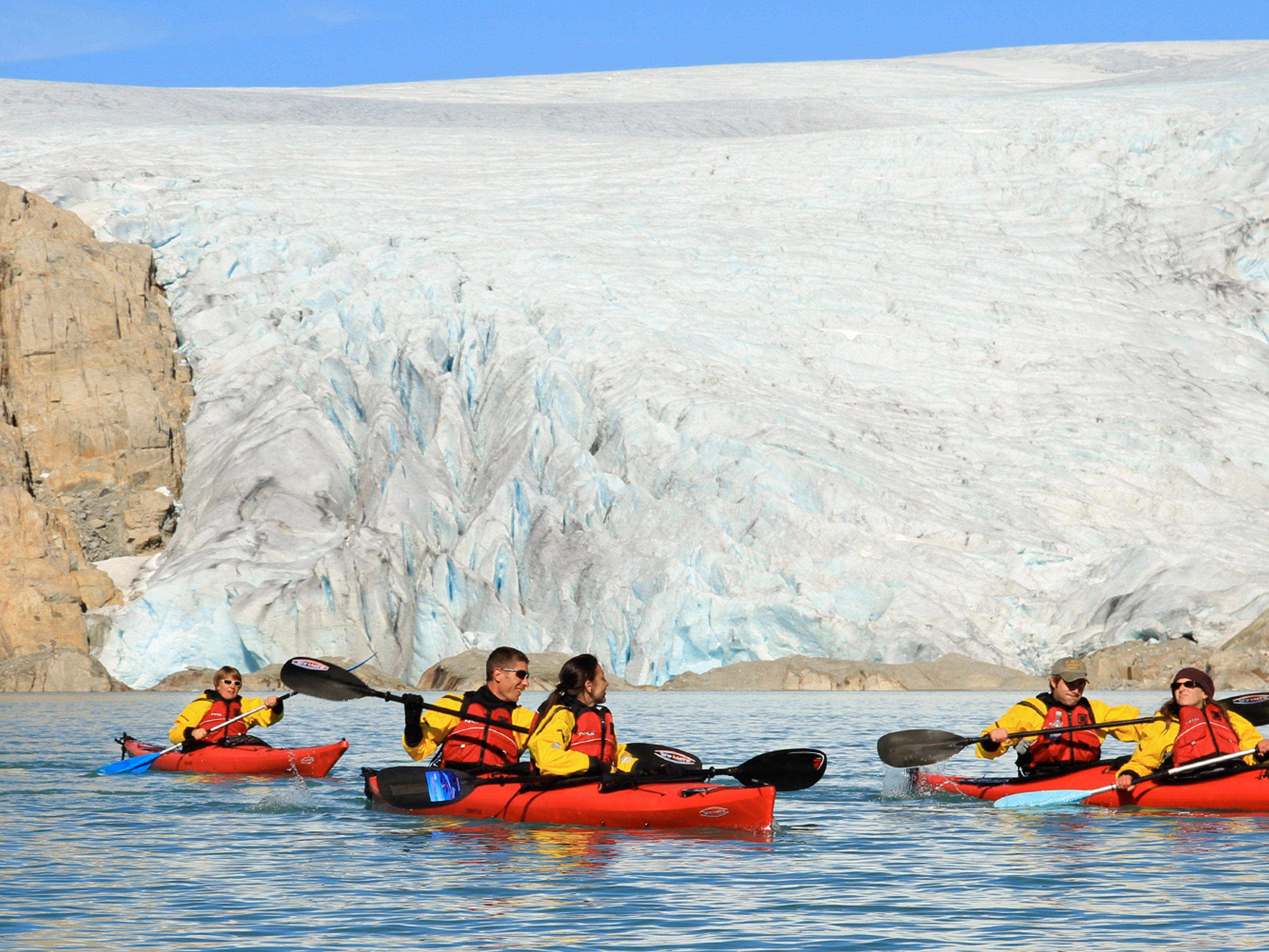 Five people kayaking close to the Folgefonna glacier in Kvinnherad