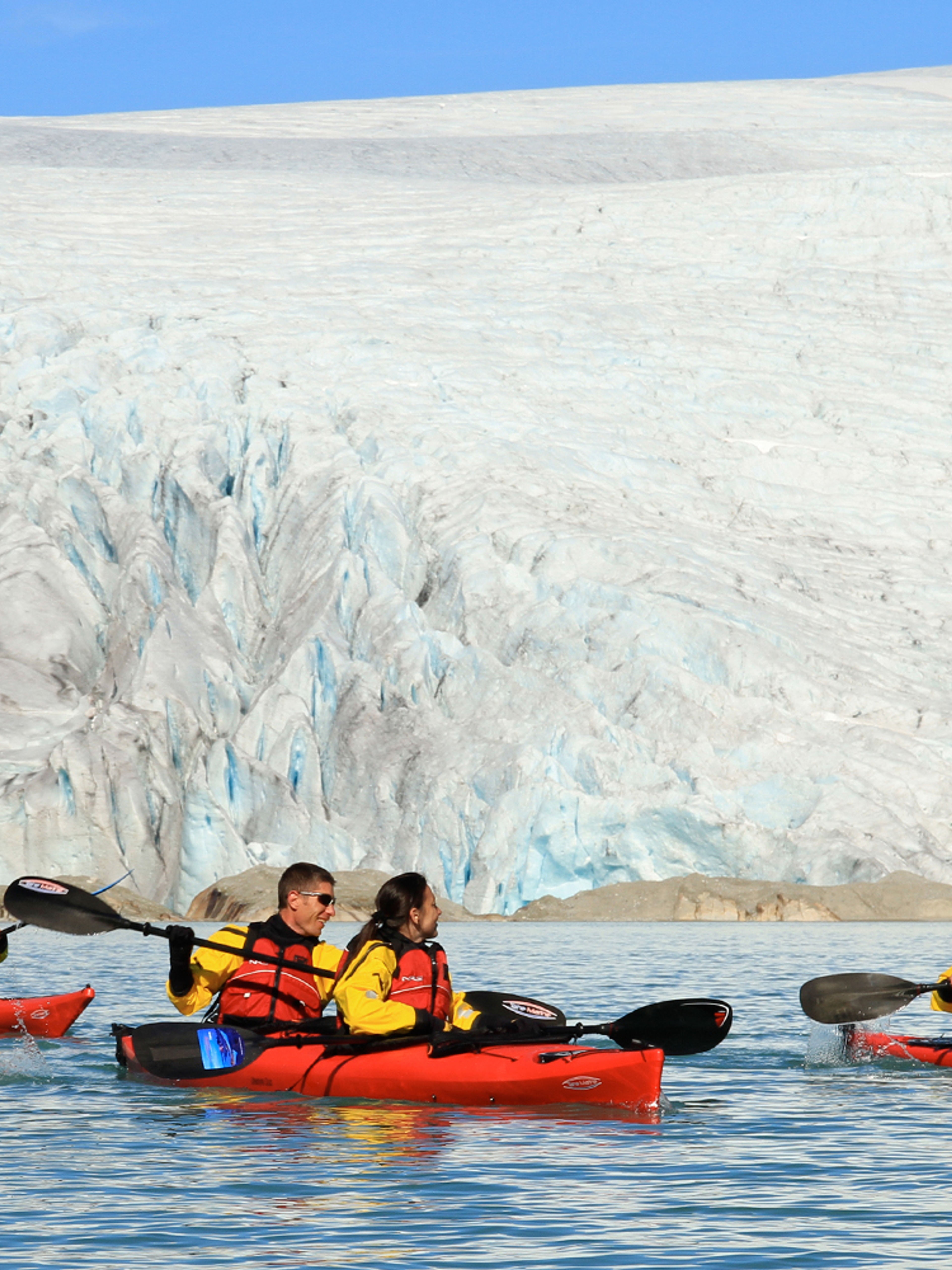 Five people kayaking close to the Folgefonna glacier in Kvinnherad
