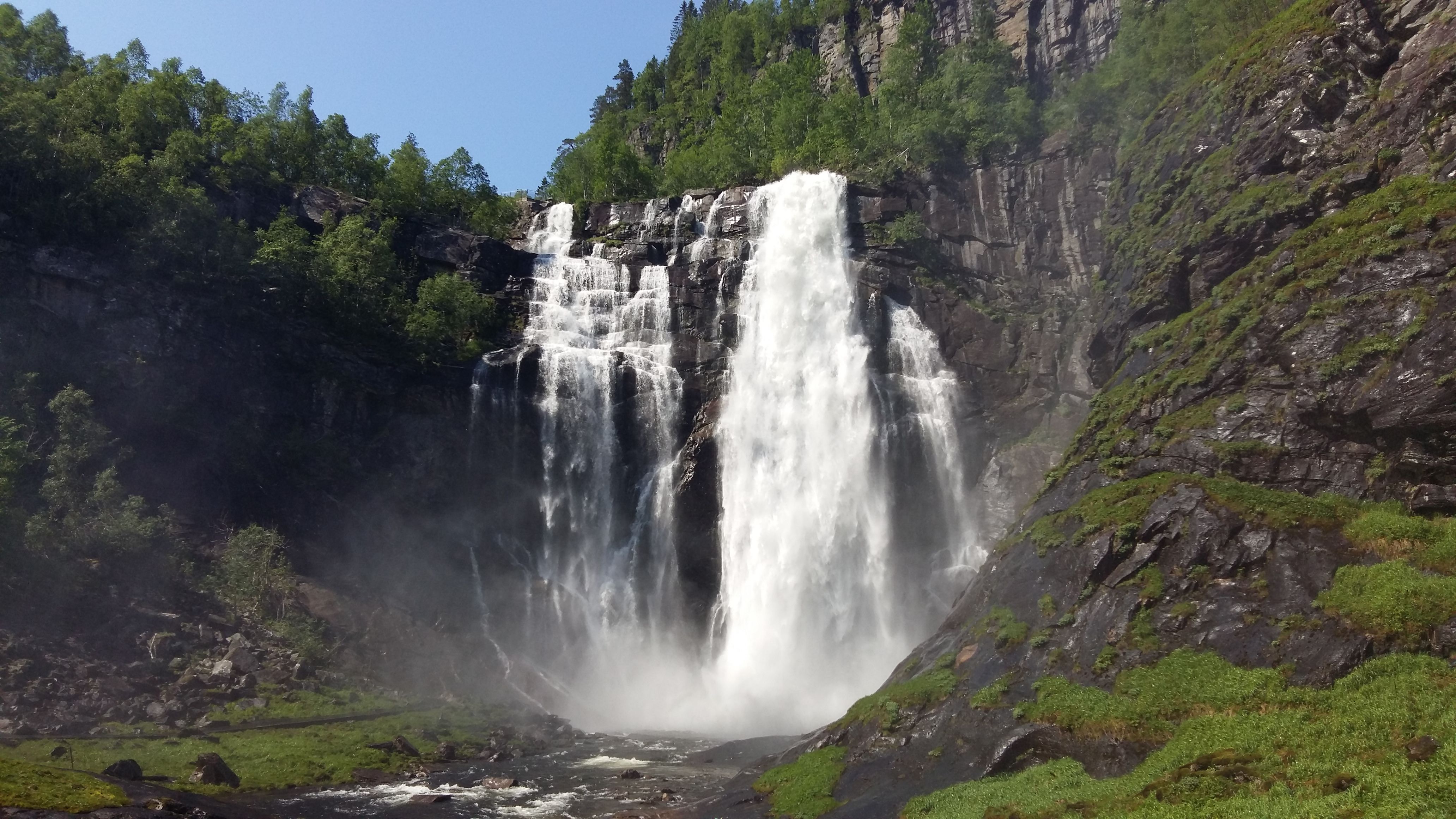 A tall waterfall in the mountains